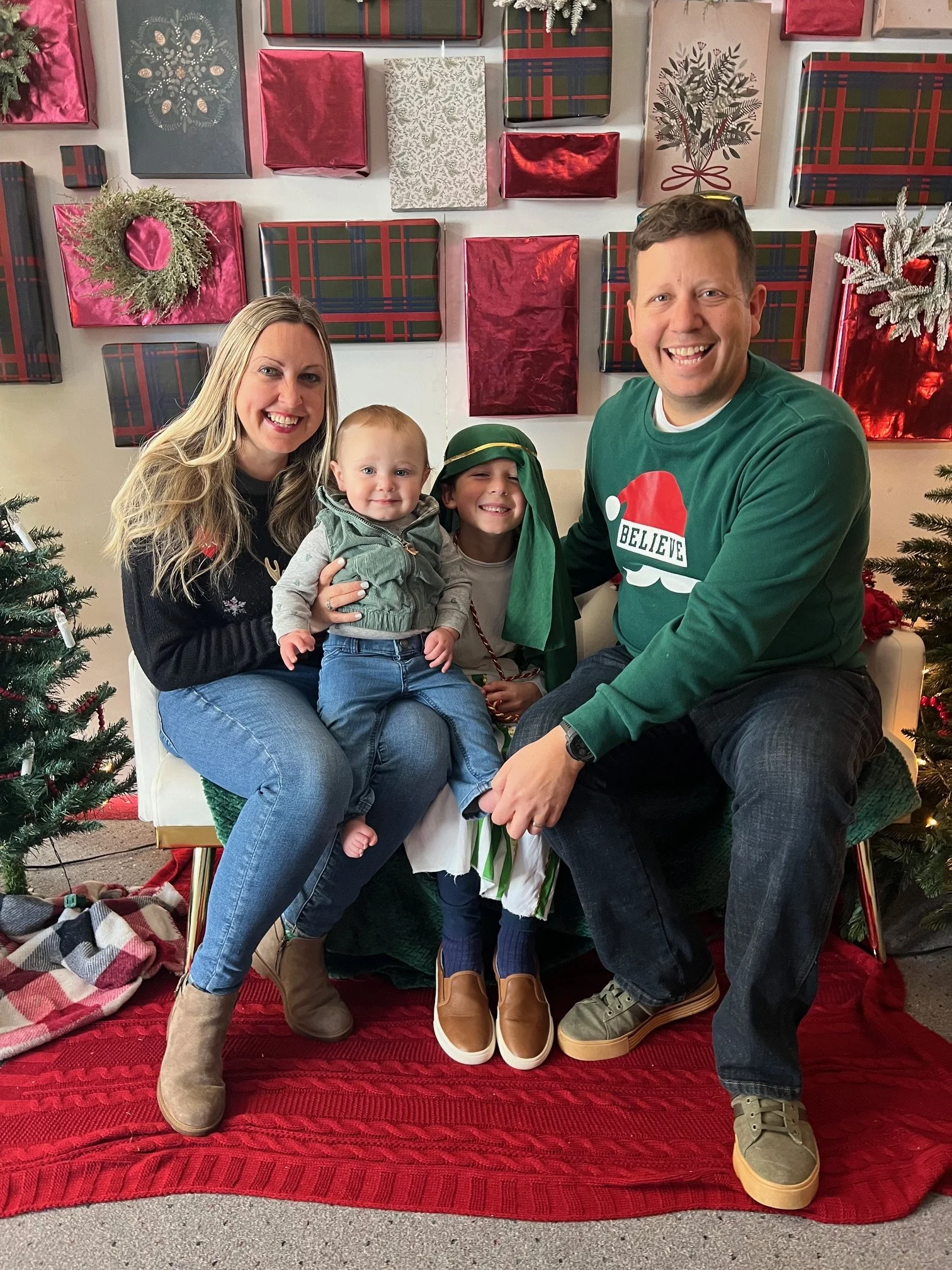 Matthew and Robin's family with a holiday photo backdrop