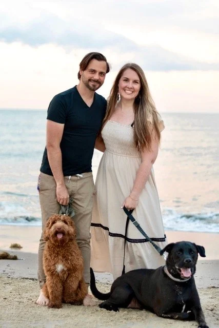 David and Rebekah on the beach with their two dogs, hoping to adopt a child
