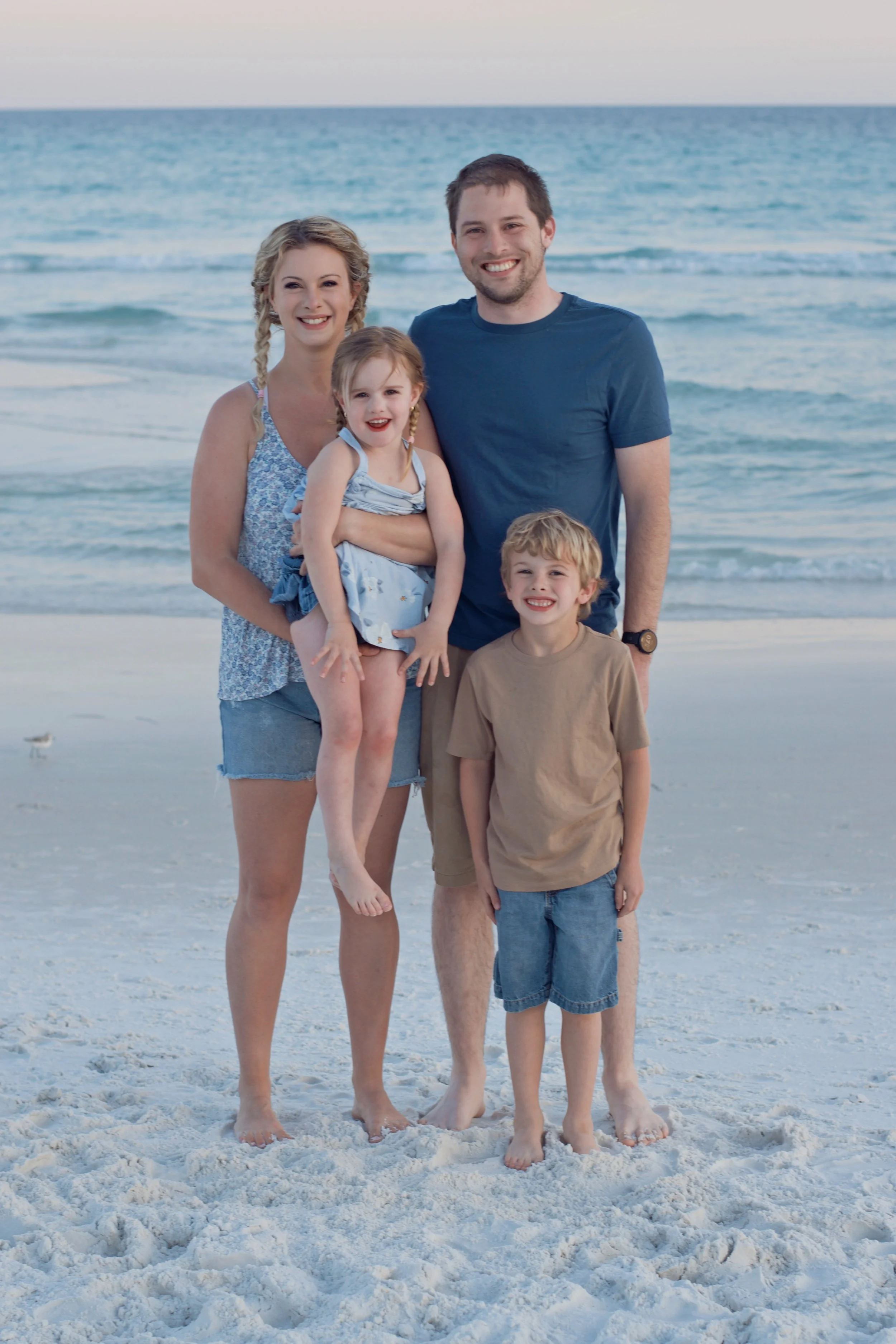 Stephen and Brandy with their two children on the beach