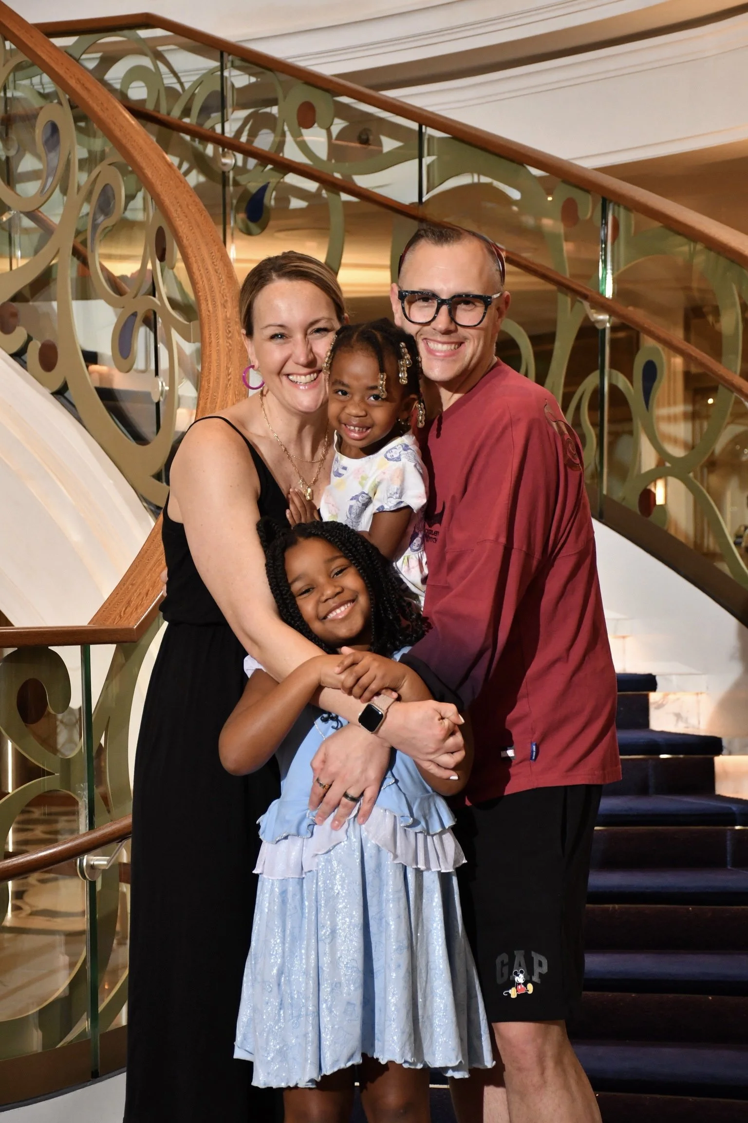 Jordan and Helene with their two daughters in front of stairs