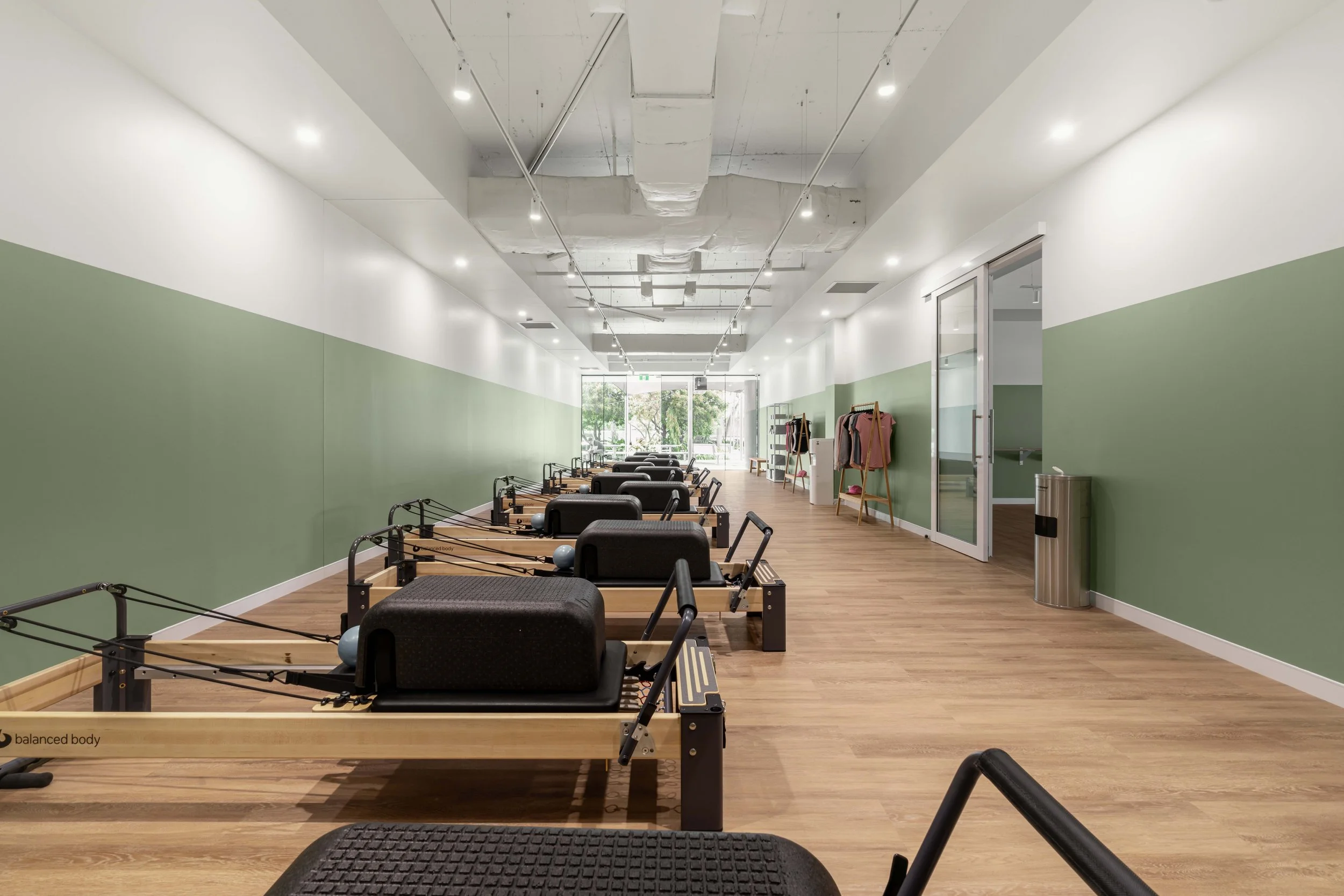 Premium Pilates Milton | Pilates Studio Interior Design Brisbane

This Premium Pilates Milton studio showcases a contemporary wellness interior designed to support movement, comfort, and client experience. The space features a calming green and white