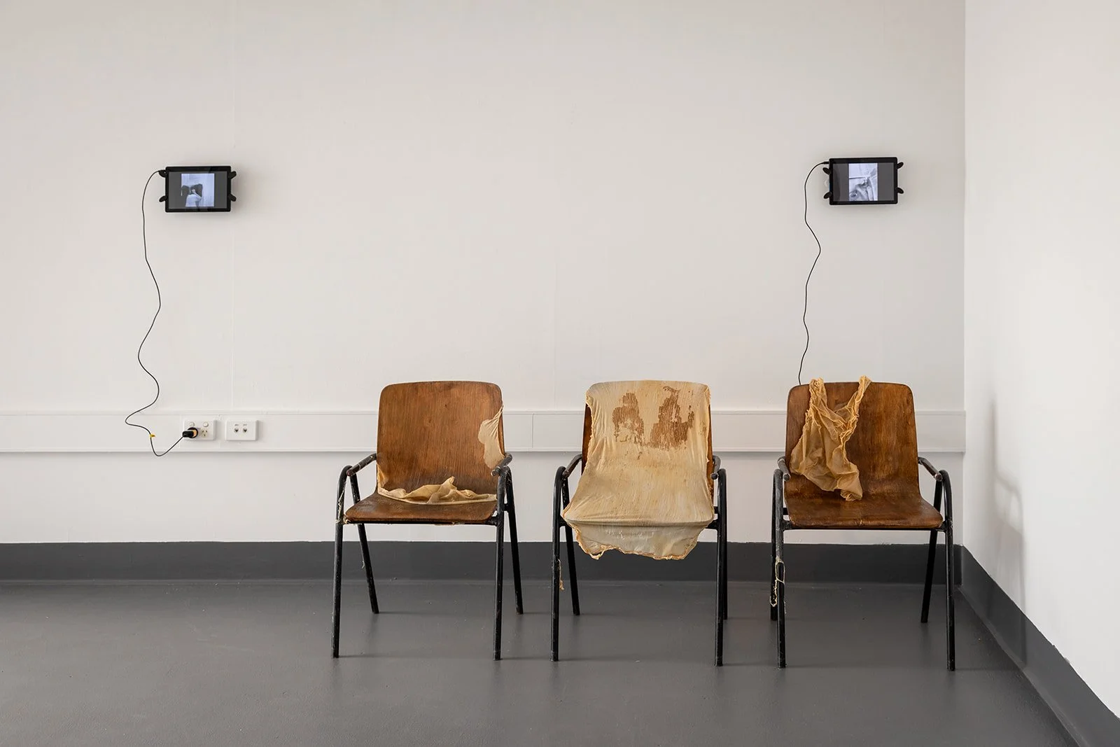 Photograph: Robyn Wood Images,
Installation View: Chair Skins Series: Chair Skin I, Chair Skin II, Chair Skin III: 3 Chairs, Latex, Performance Shower Drawing: Looped Video, Performance Goggly Eye Looped Video.