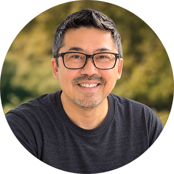 Samuel Choy, wildlife and nature photographer, smiling in front of a blurred green background