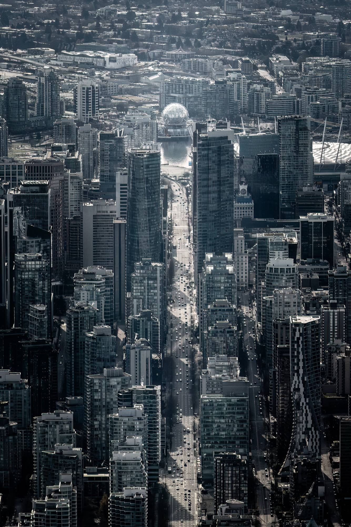 Aerial view of downtown Vancouver with Science World at the end of Georgia Street, shot from a helicopter. Photo by Samuel Choy