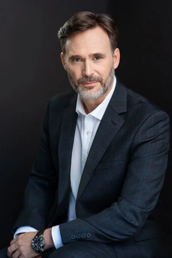 Corporate portrait of a senior businessman in a dark suit