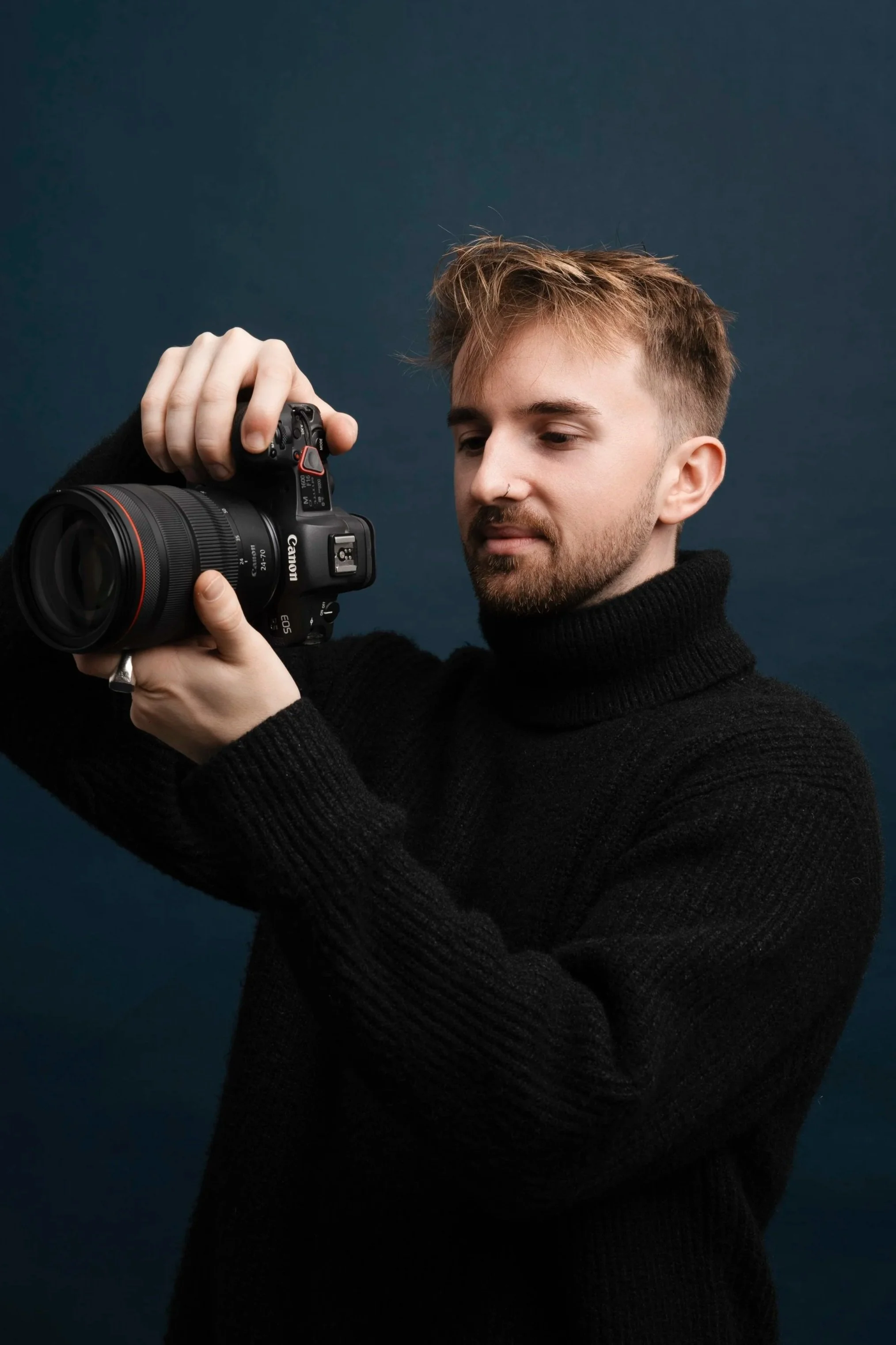 Dean Bartolo, corporate headshot photographer in Leeds, holding a camera