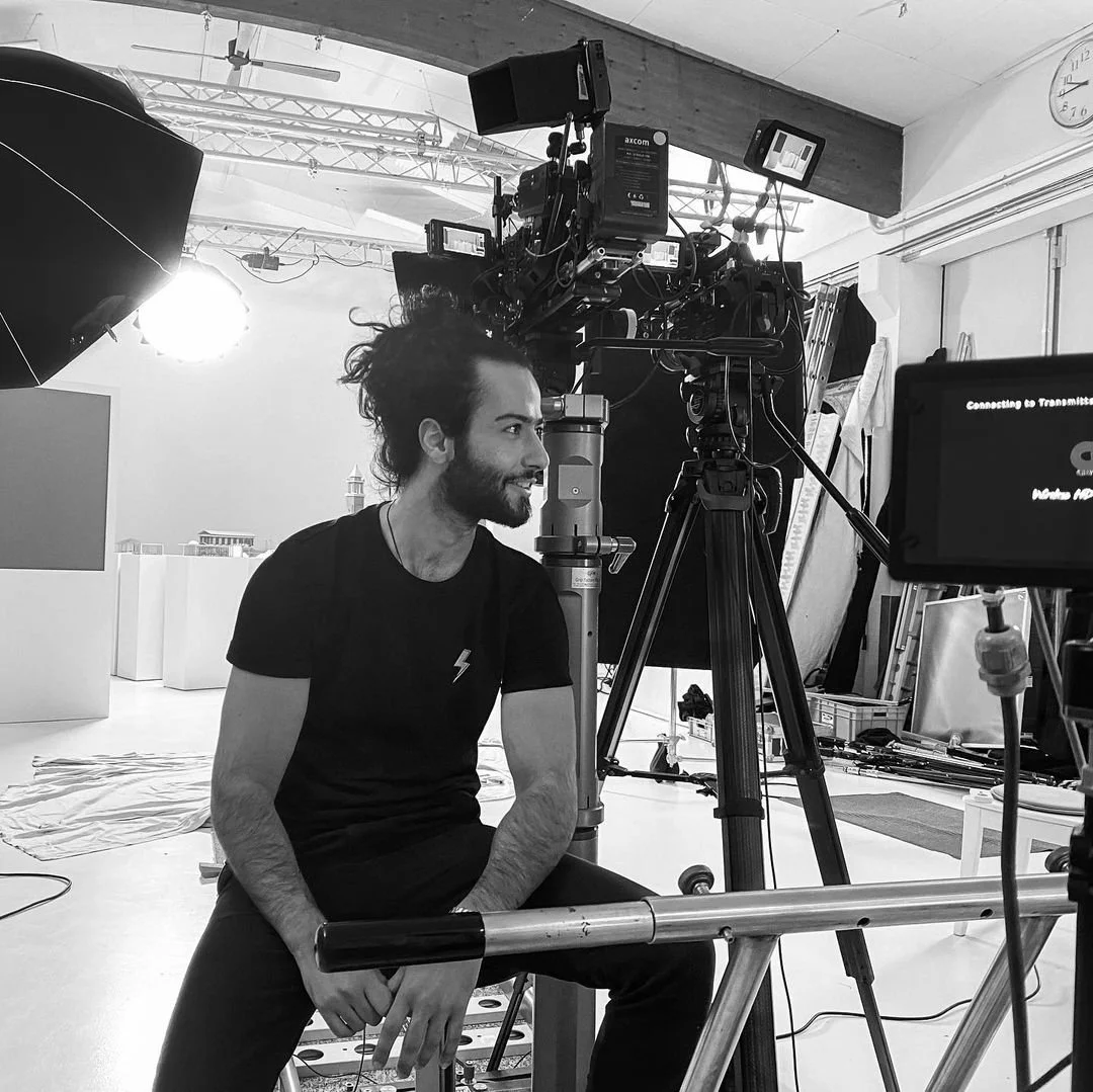 Man sitting in photography studio near camera equipment