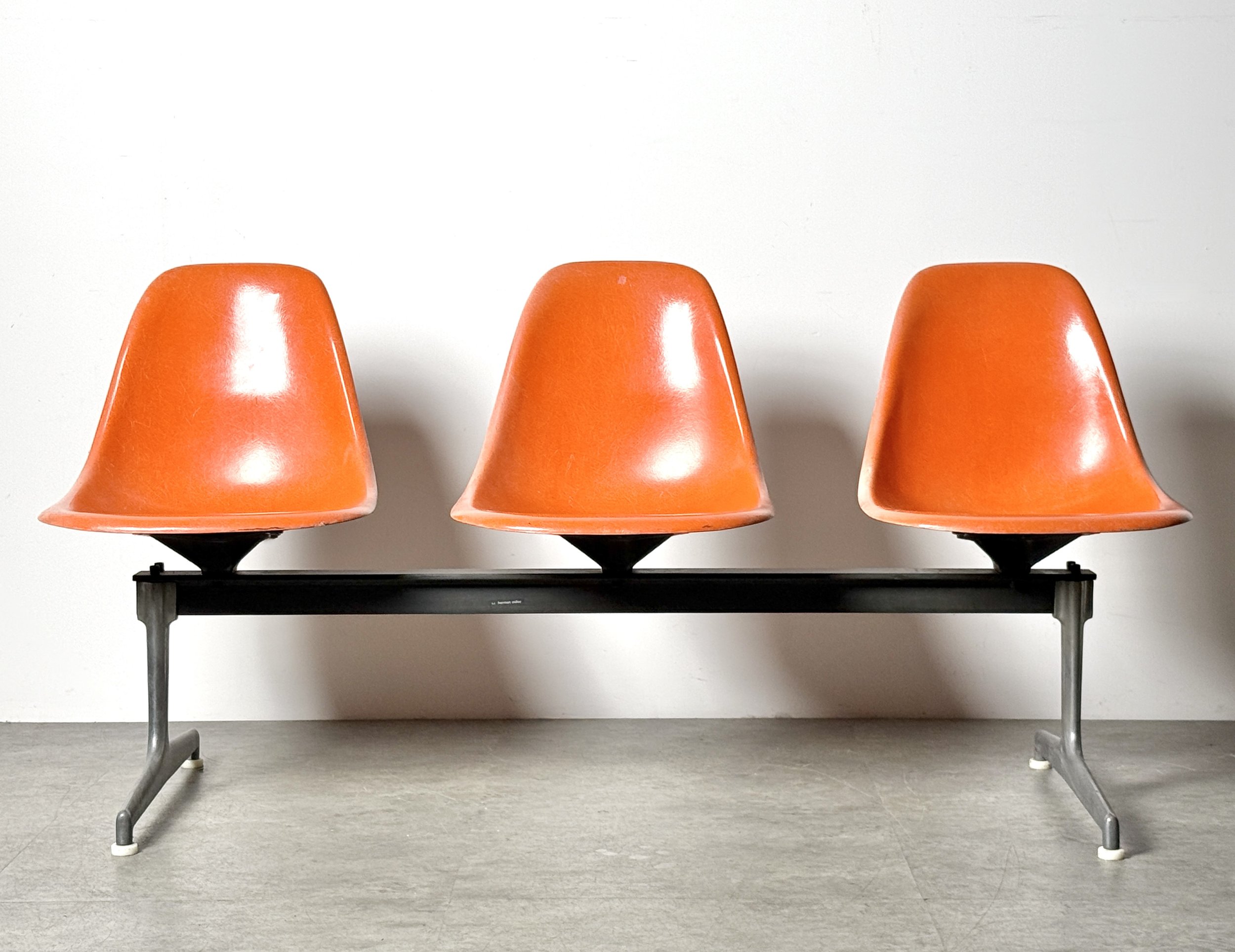 vintage mid century modern detroit michigan herman miller charles eames fiberglass shell chair orange tandem bench office lobby airport bench