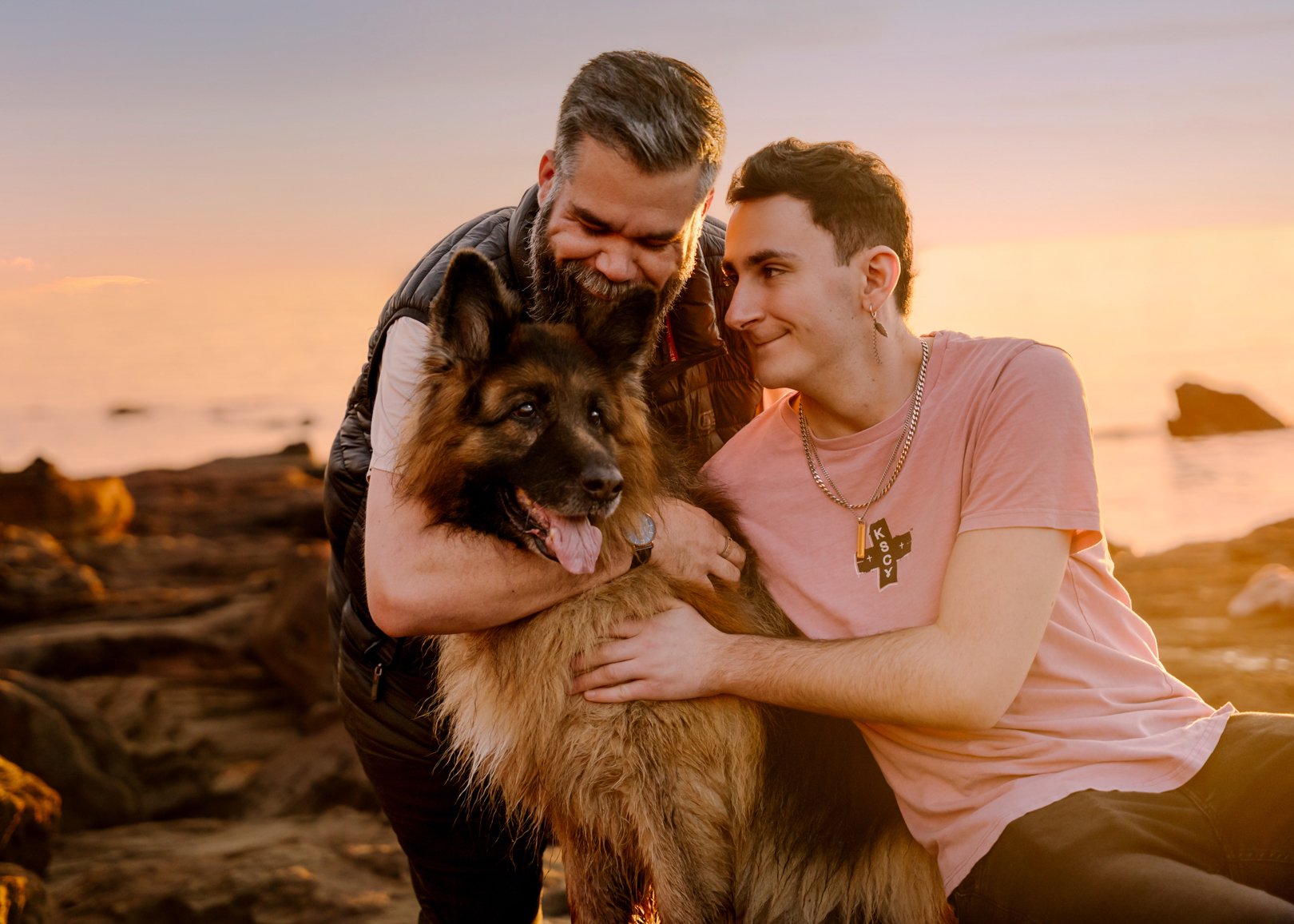 Dan and Josh on the rocks at sunset with Dexter, their twelve year old German Shepherd