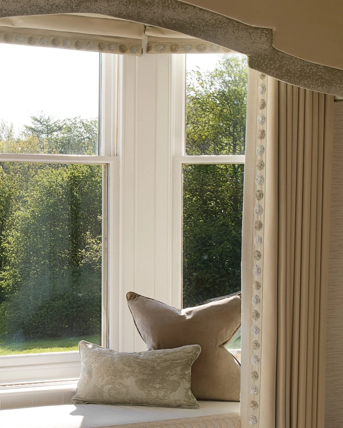 A window seat creates a moment within a bedroom.

For our clients, this becomes a quiet place to enjoy the scenery.🪴

With a bespoke layered pelmet, custom blinds and full-height curtains, the view is framed with softness. Finished with bespoke cush
