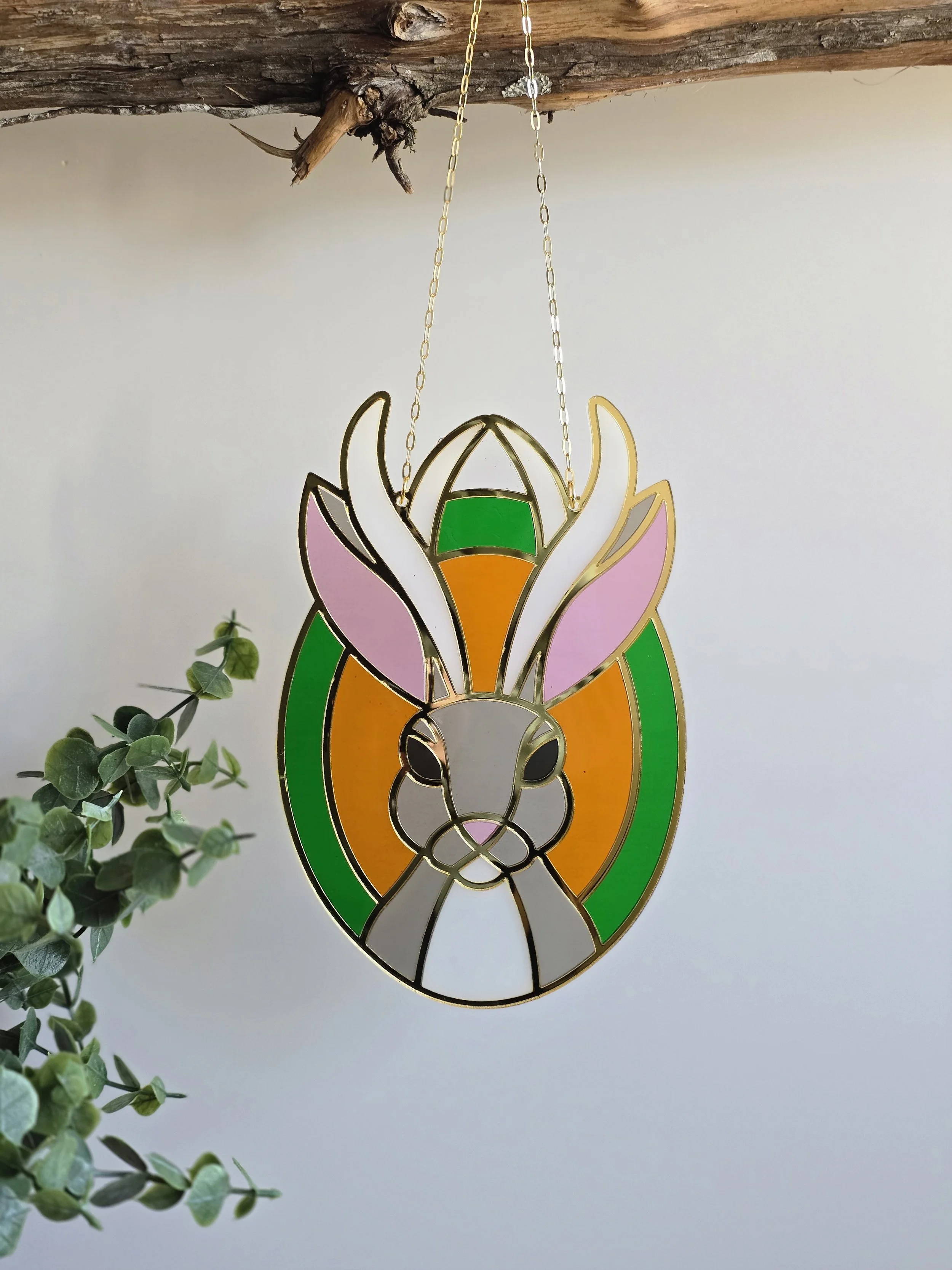 Layered acrylic jackalope suncatcher inspired by woodland folklore