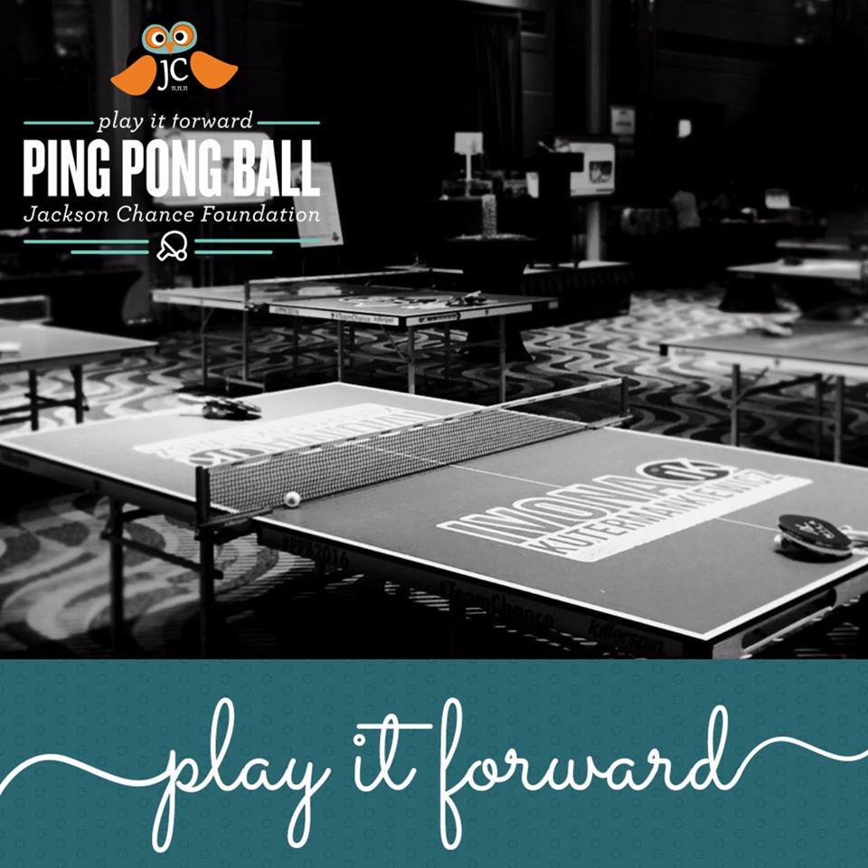 Ping pong tables set up for an event hosted by the Jackson Chance Foundation, with the text "play it forward PING PONG BALL."