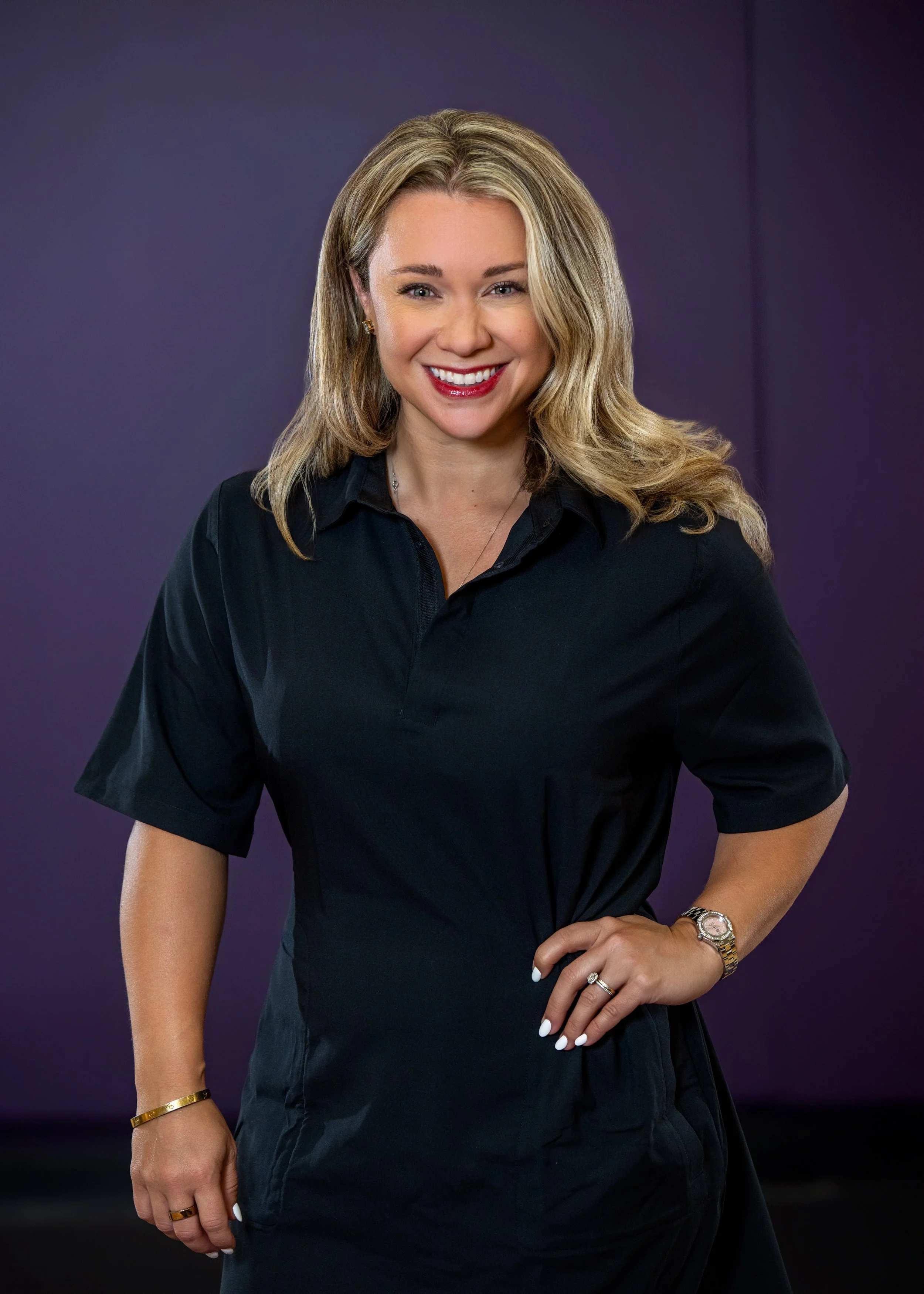 Smiling person with blonde hair at an event indoors