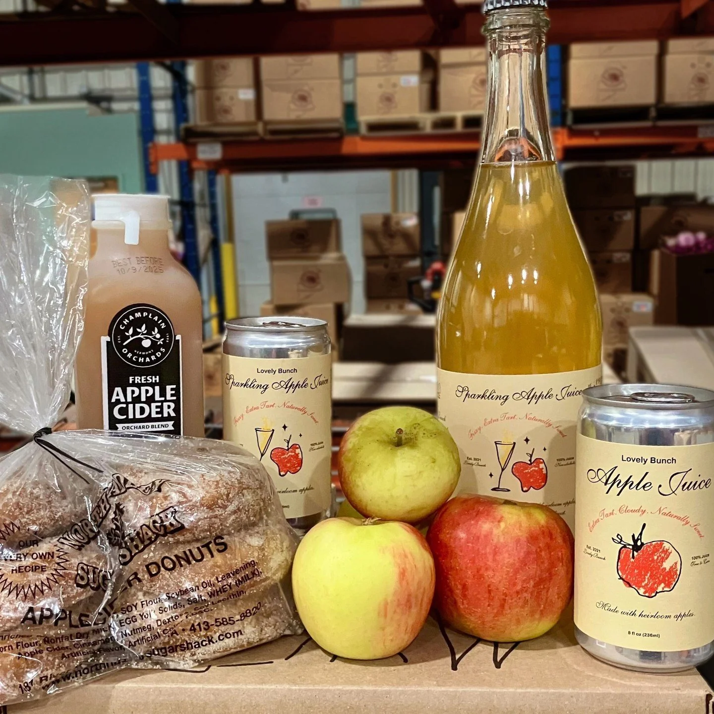 It's an apple bonanza at the warehouse! 🍎🍾 @northhadleysugarshack cider donuts, @champlainorchards fresh cider, @lovelybunchjuice (both sparkling and still!), @scottfarmvt heirloom apples, and more. We're celebrating apples in every form!