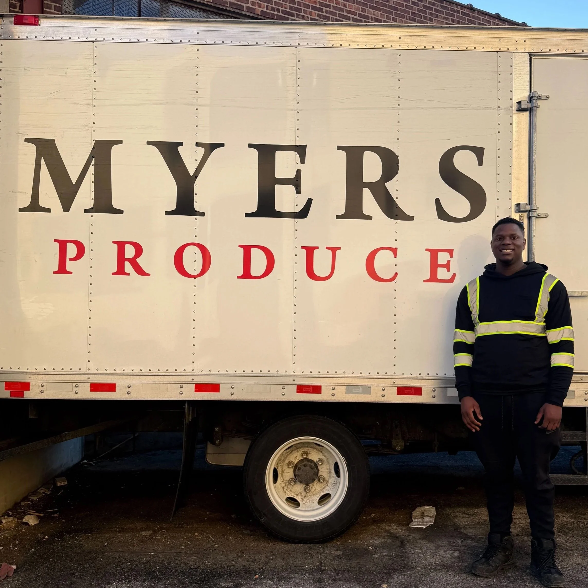 Diandre standing next to a Myers truck