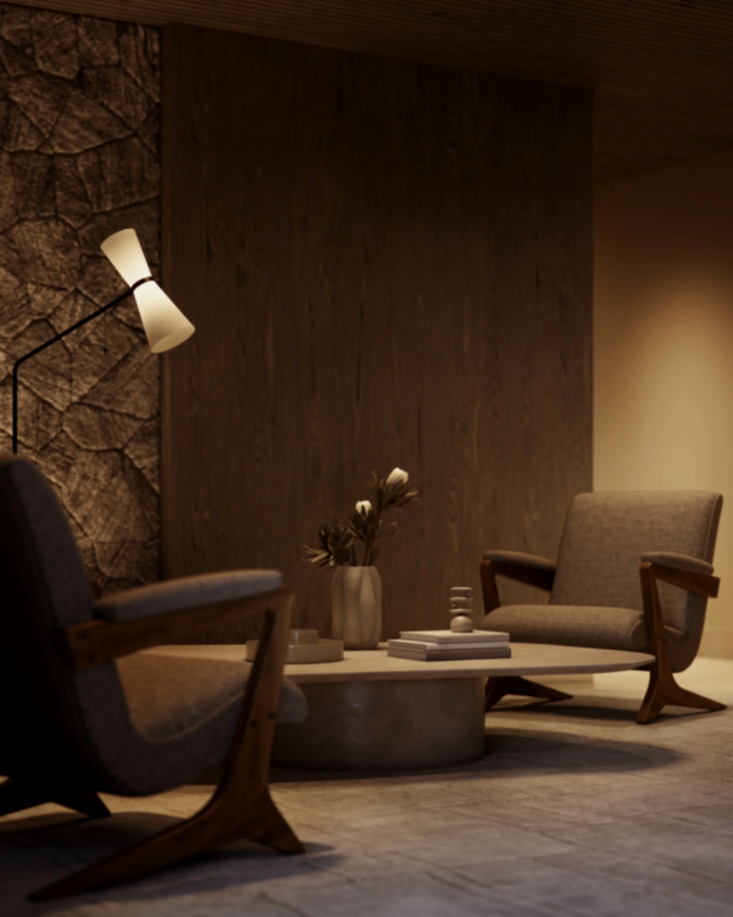 A cozy living room corner with a stone accent wall, a wooden wall panel, a modern floor lamp, a ceramic vase with dried flowers, and two cushioned armchairs on wood flooring.