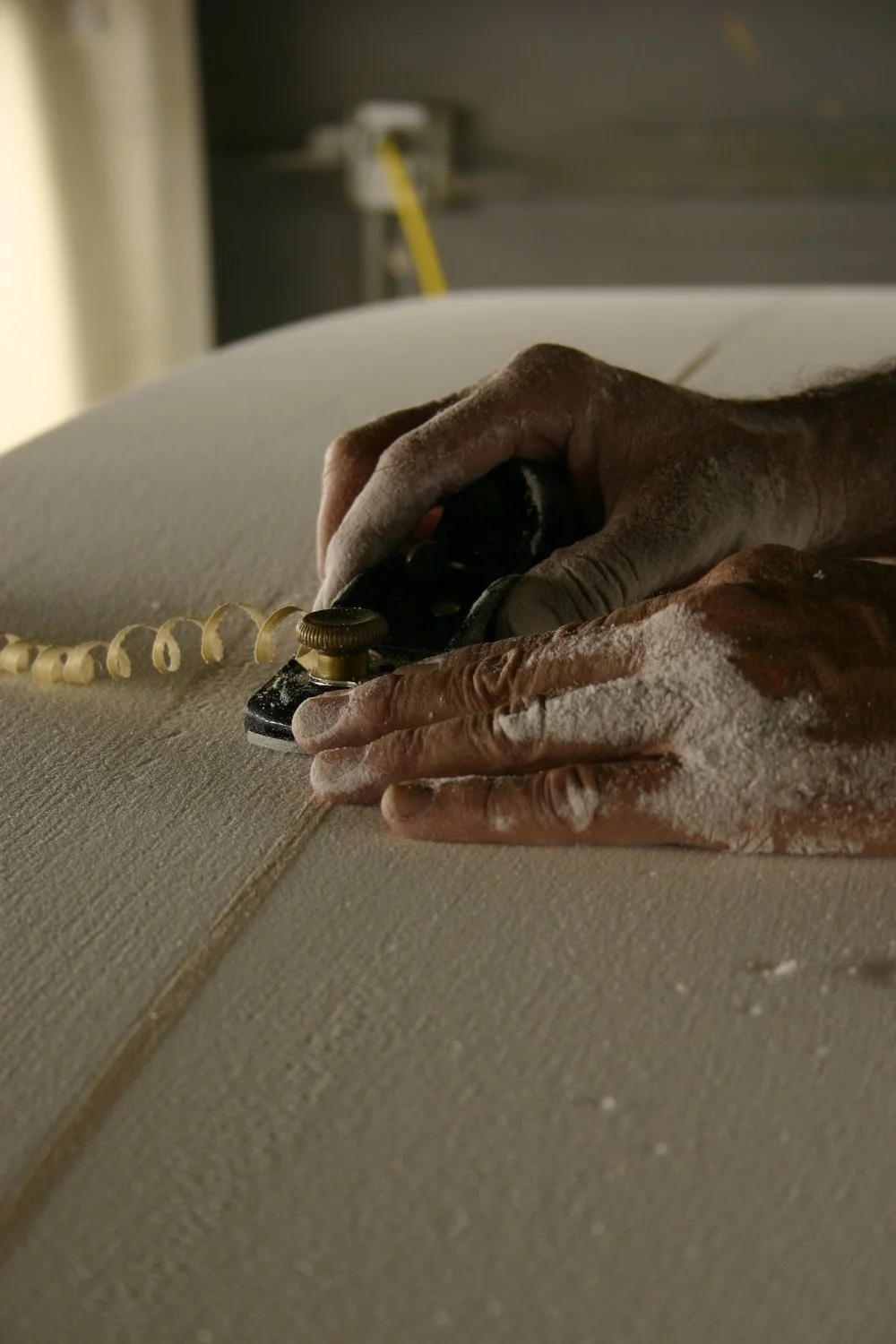 Bruce Jones shaping a surfboard
