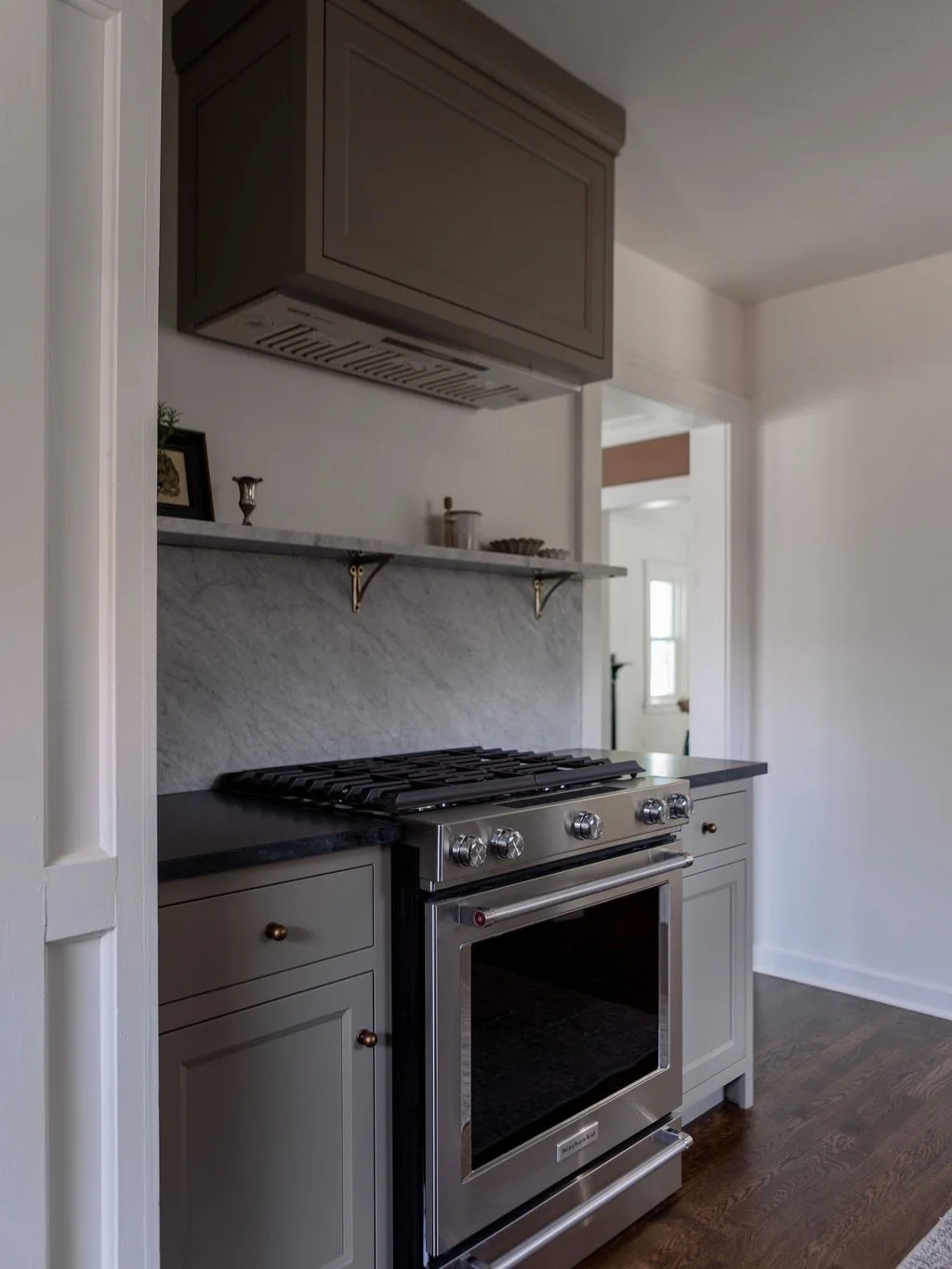 I love a dramatic before and after, and this one delivers! We replaced laminate floors with solid white oak, swapped dated cabinetry for beautiful flush inset cabinetry, and upgraded the countertops to beautiful natural stone. What was once an open r