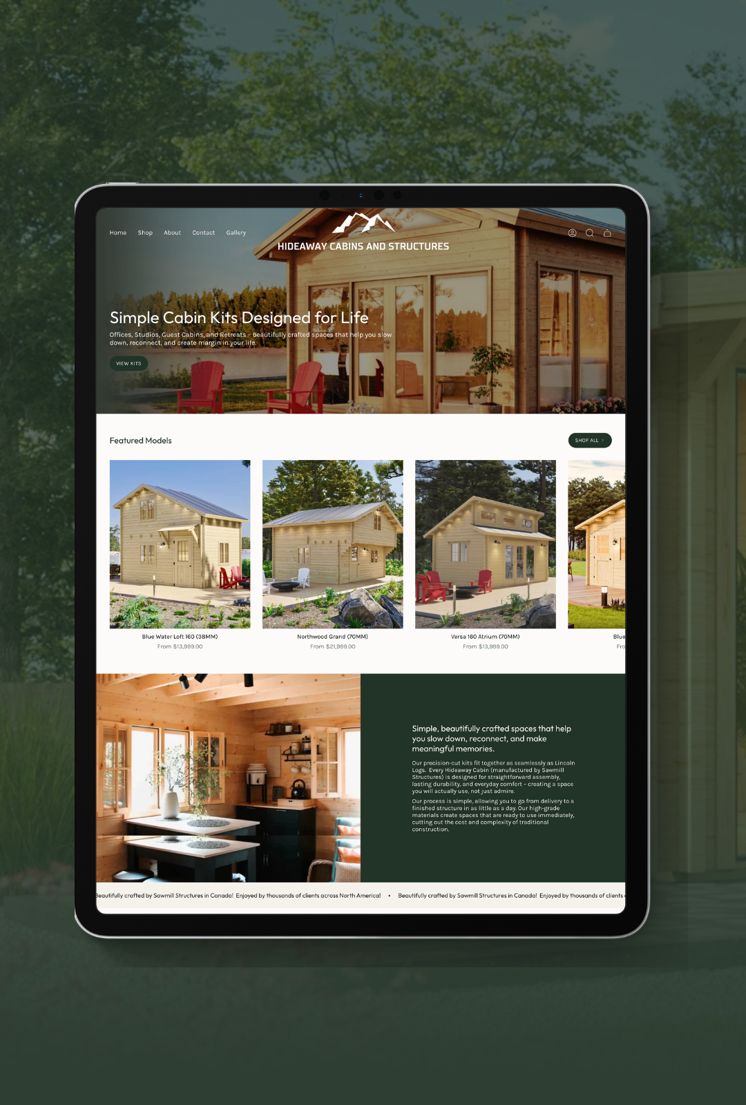 Tablet displaying a website about hideaway cabins and structures with images of various wooden cabin models and interior.