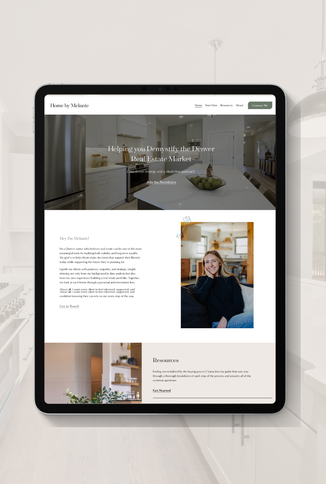 Screenshot of a real estate website displaying the home page with a kitchen image, a woman sitting on a couch, and interior decor.