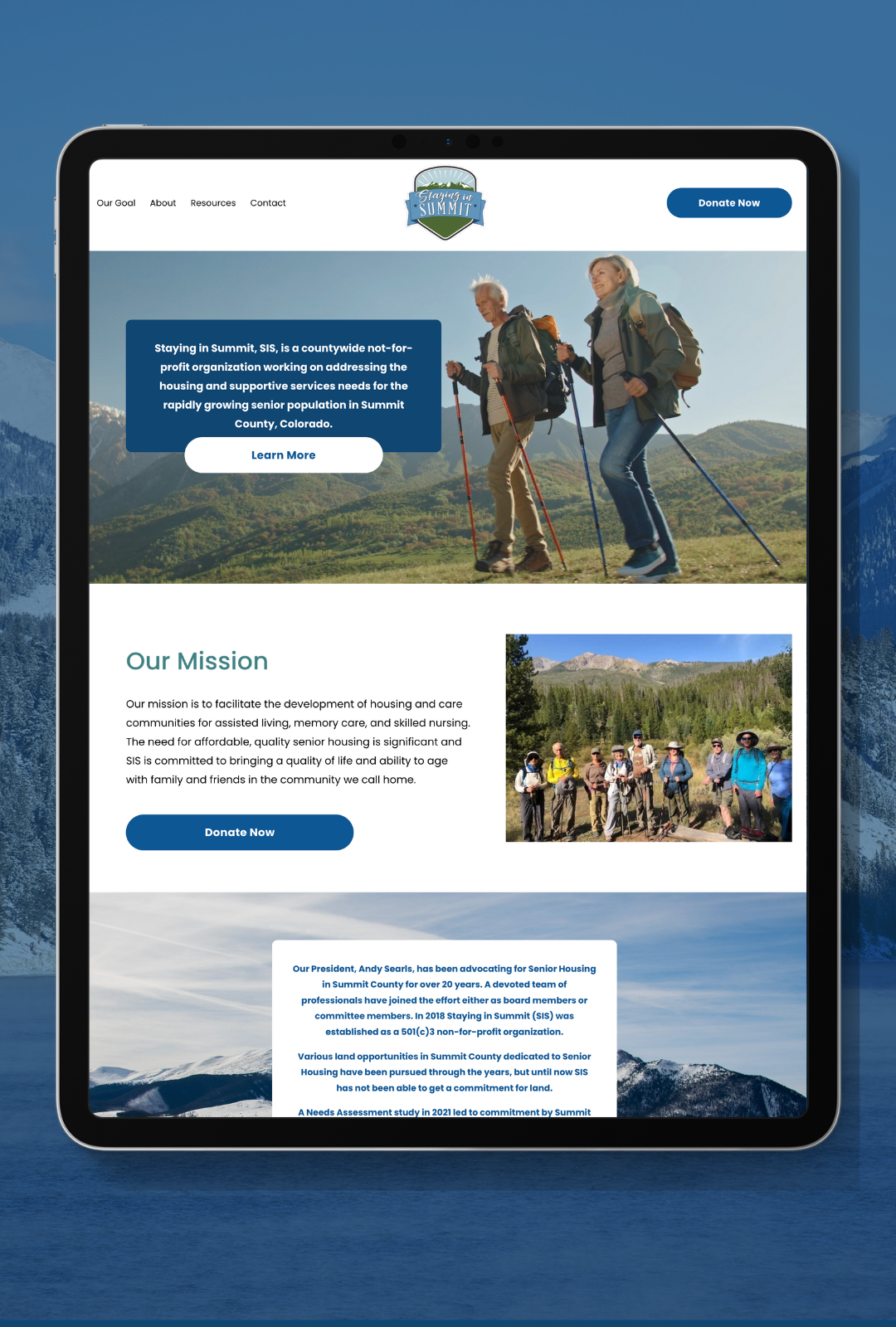 Tablet displaying the "Staying in Summit" nonprofit webpage, featuring hiking seniors, mission statement, and donation buttons against a mountainous backdrop.