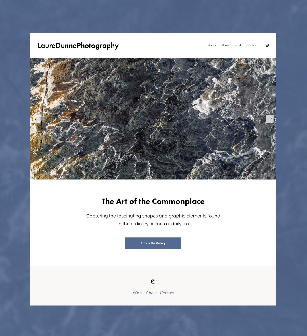 Photograph of a rocky shoreline with dark and light stones, possibly captured from above.