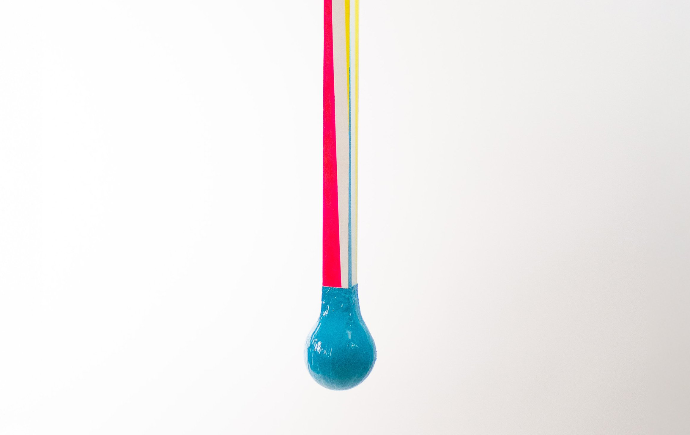 Colorful strings hanging with a bulbous blue end.