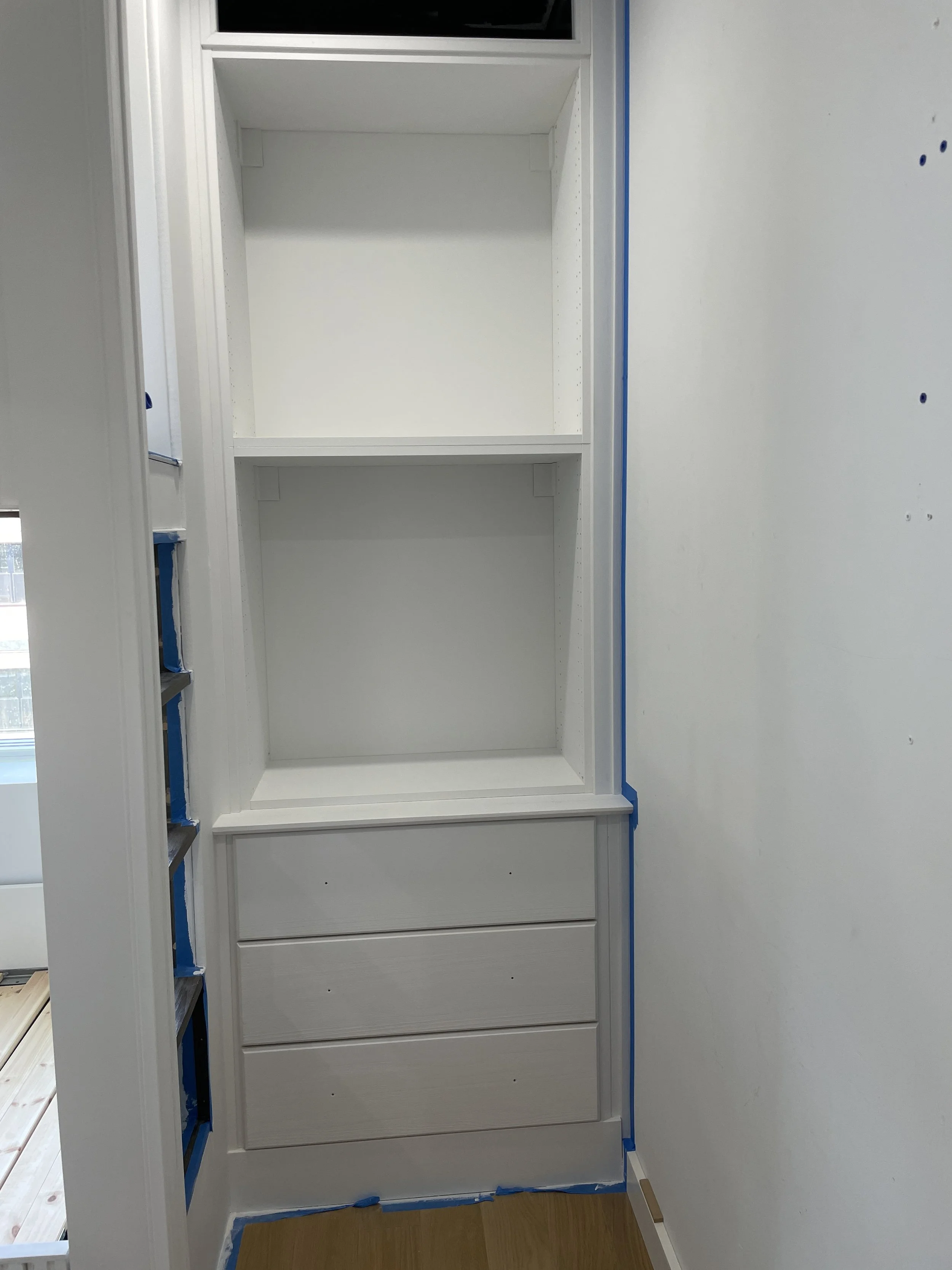 IKEA Sektion cabinet painted white trimmed out as built-in