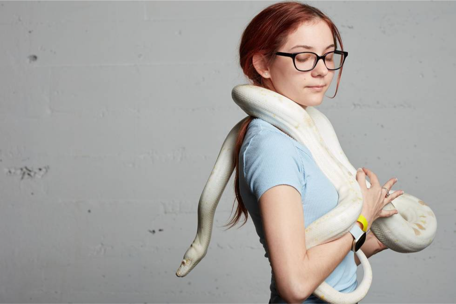 A female model is photographed with a snake during a shoot in DTLA