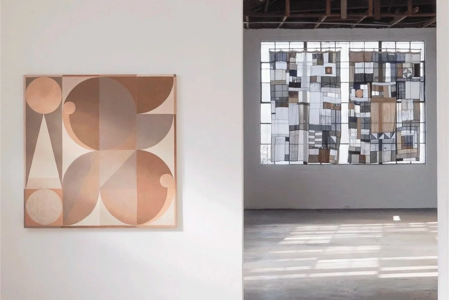 Art hanging on white walls at Mica Studios