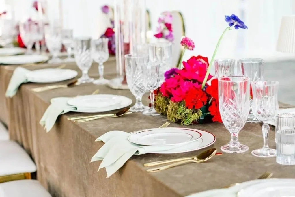 A table setting with flowers and wine glasses ready for guests at Mica Studios wedding venue