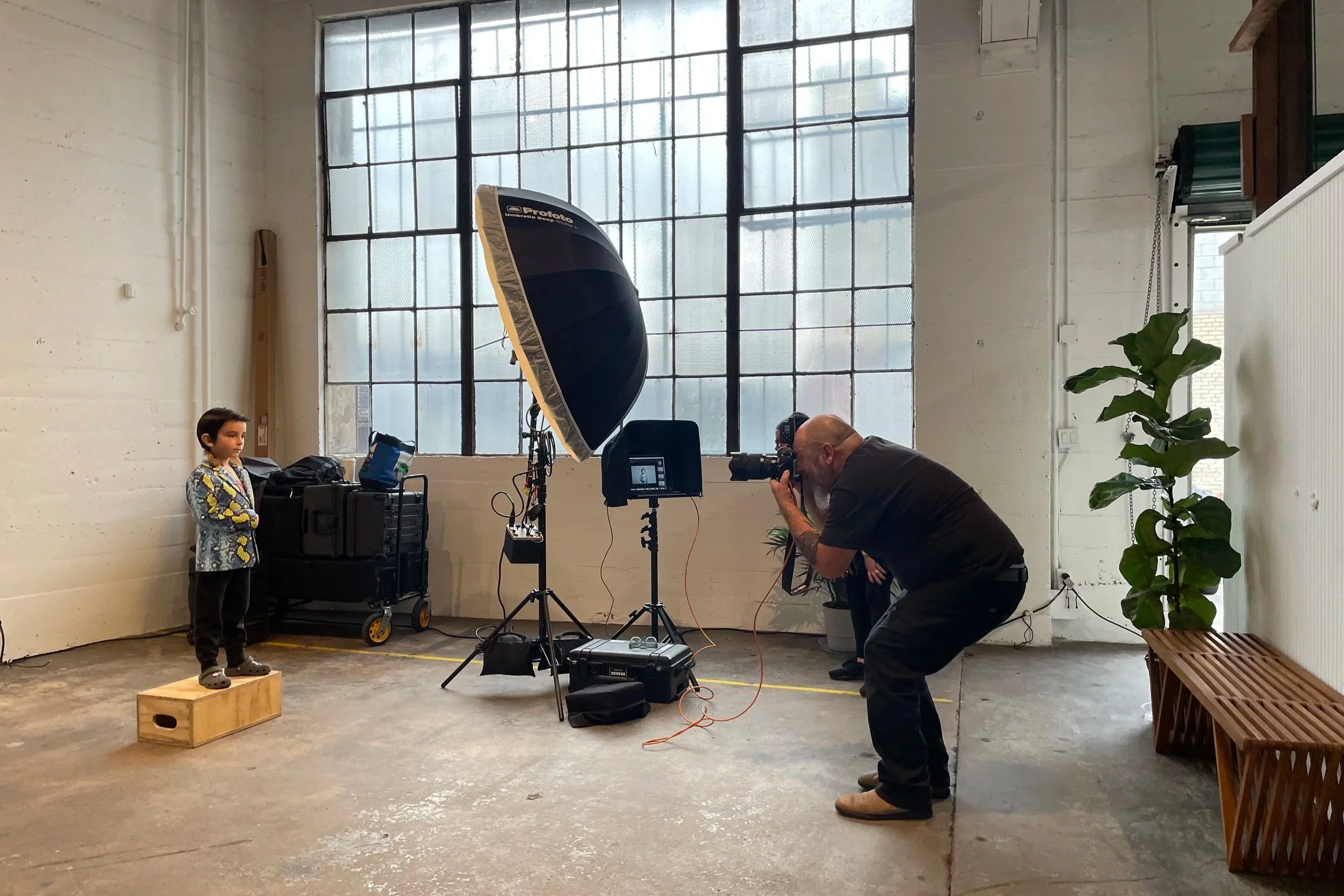A photoshoot takes place for a campaign at Mica Studios featuring a child being photographed