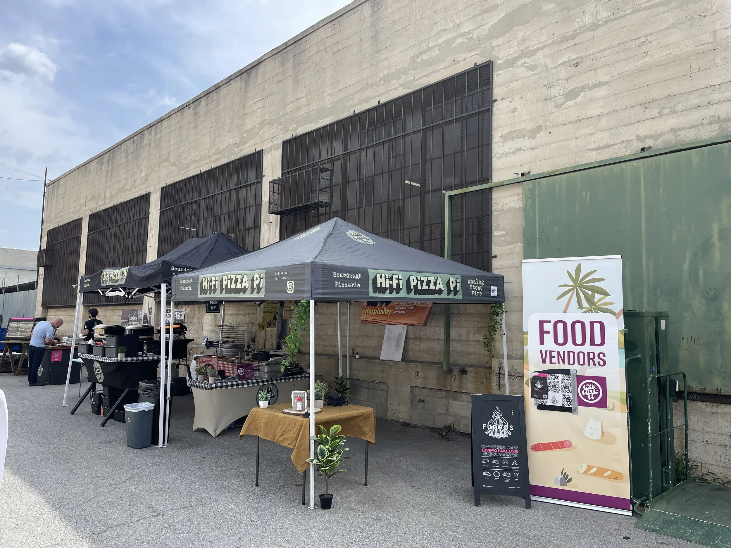 Displaying a food pop-up event outside at Mica Studios with multiple booths