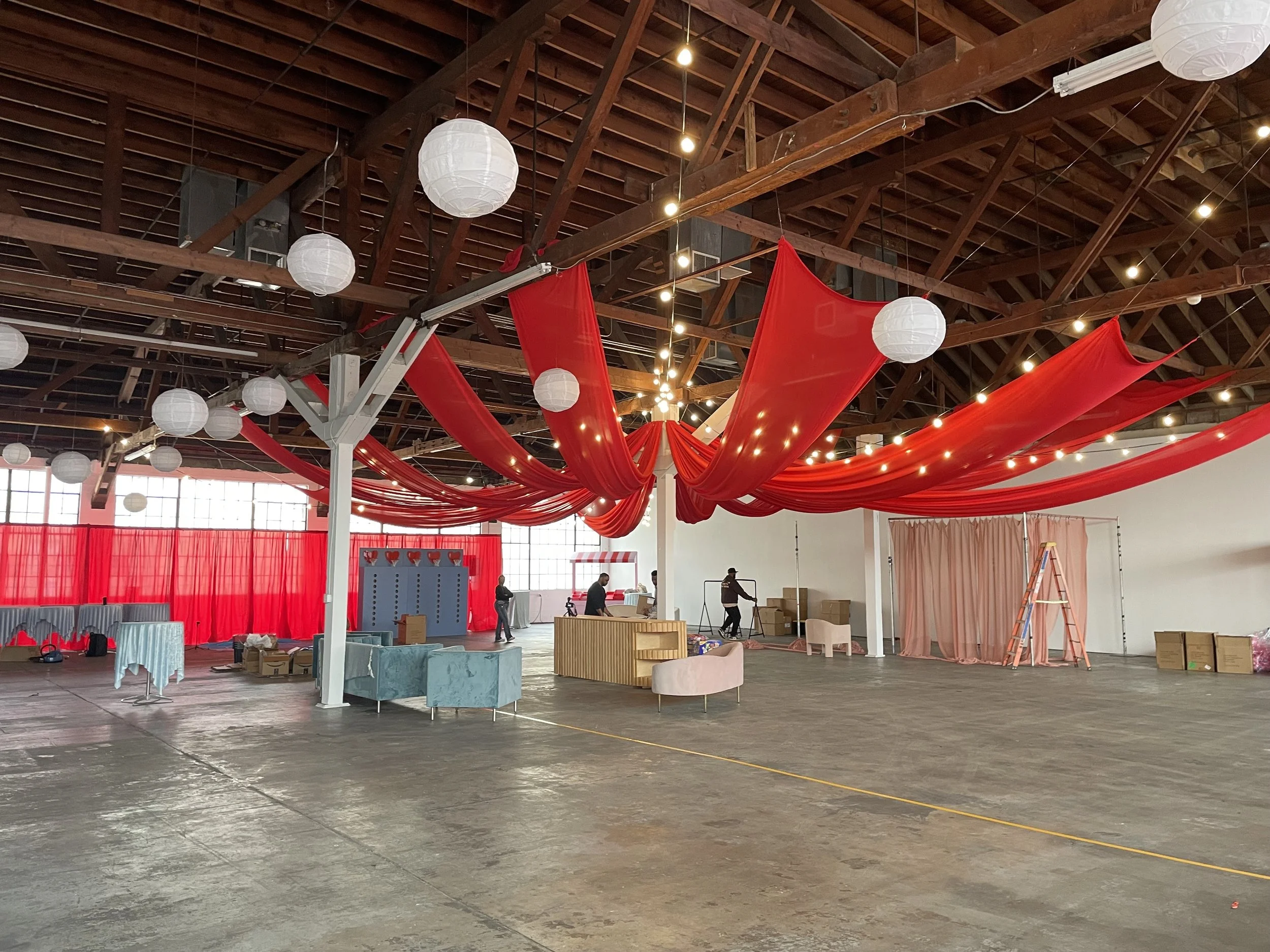 Event set-up at Mica Studios with fabric hanging from the wooden trussing