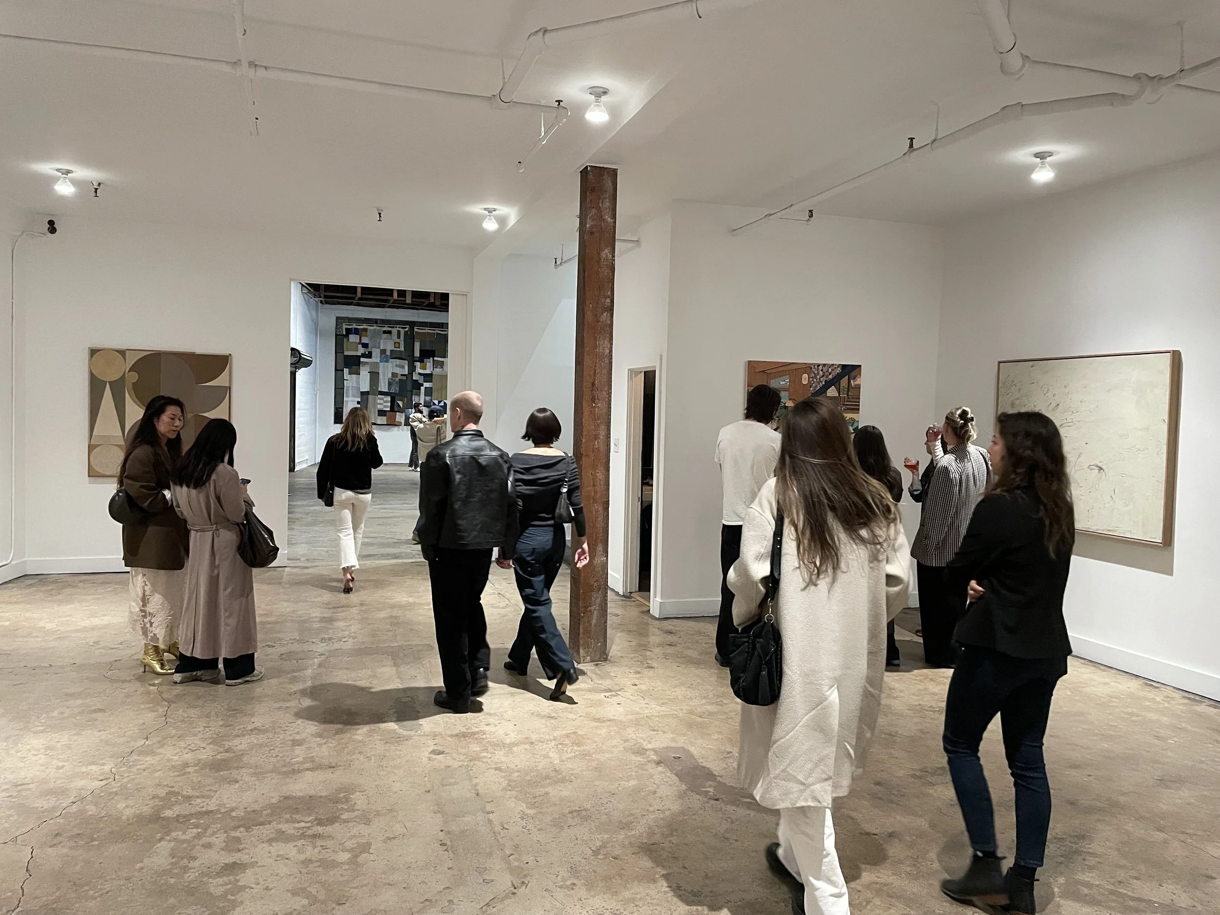 People walking through gallery show at Mica Studios