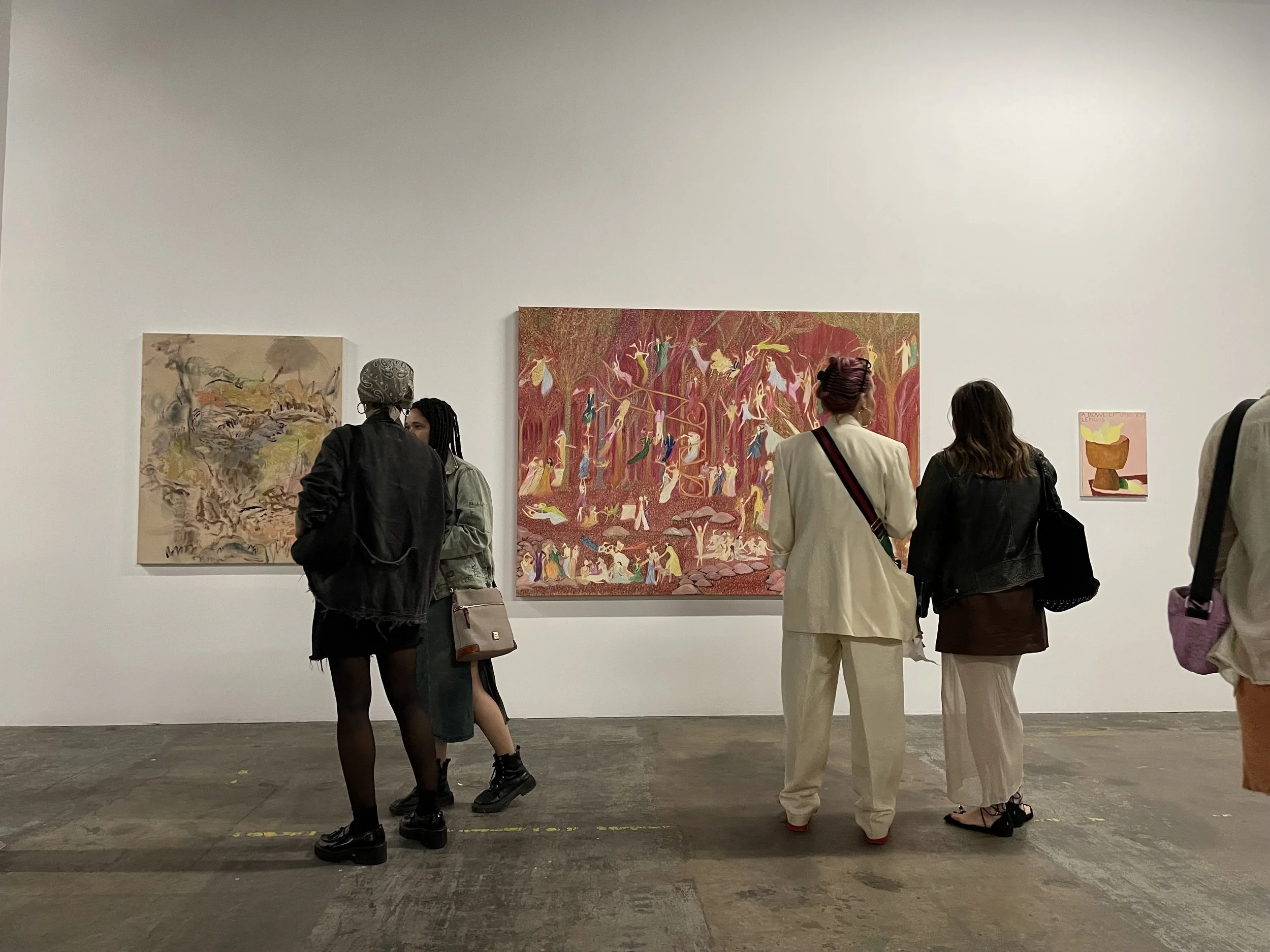 Guests looking at art on a wall during a gallery opening
