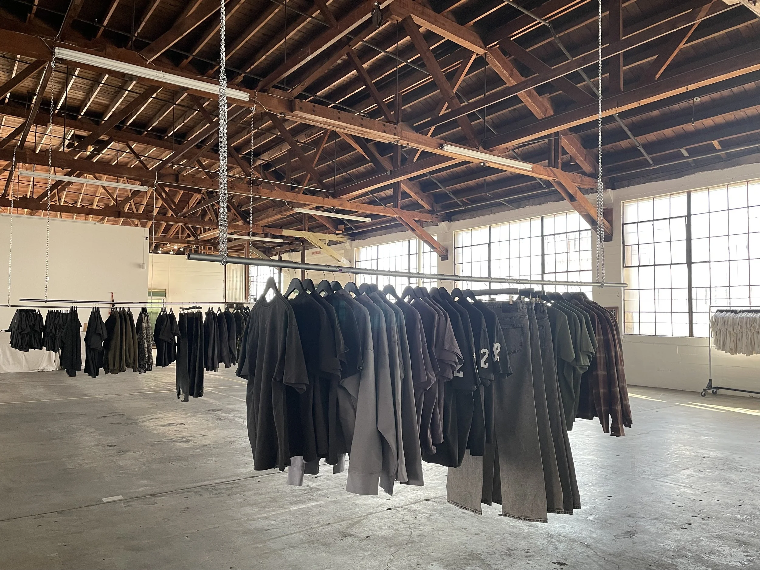 Clothing racks hanging at Mica Studios for a clothing pop-up event