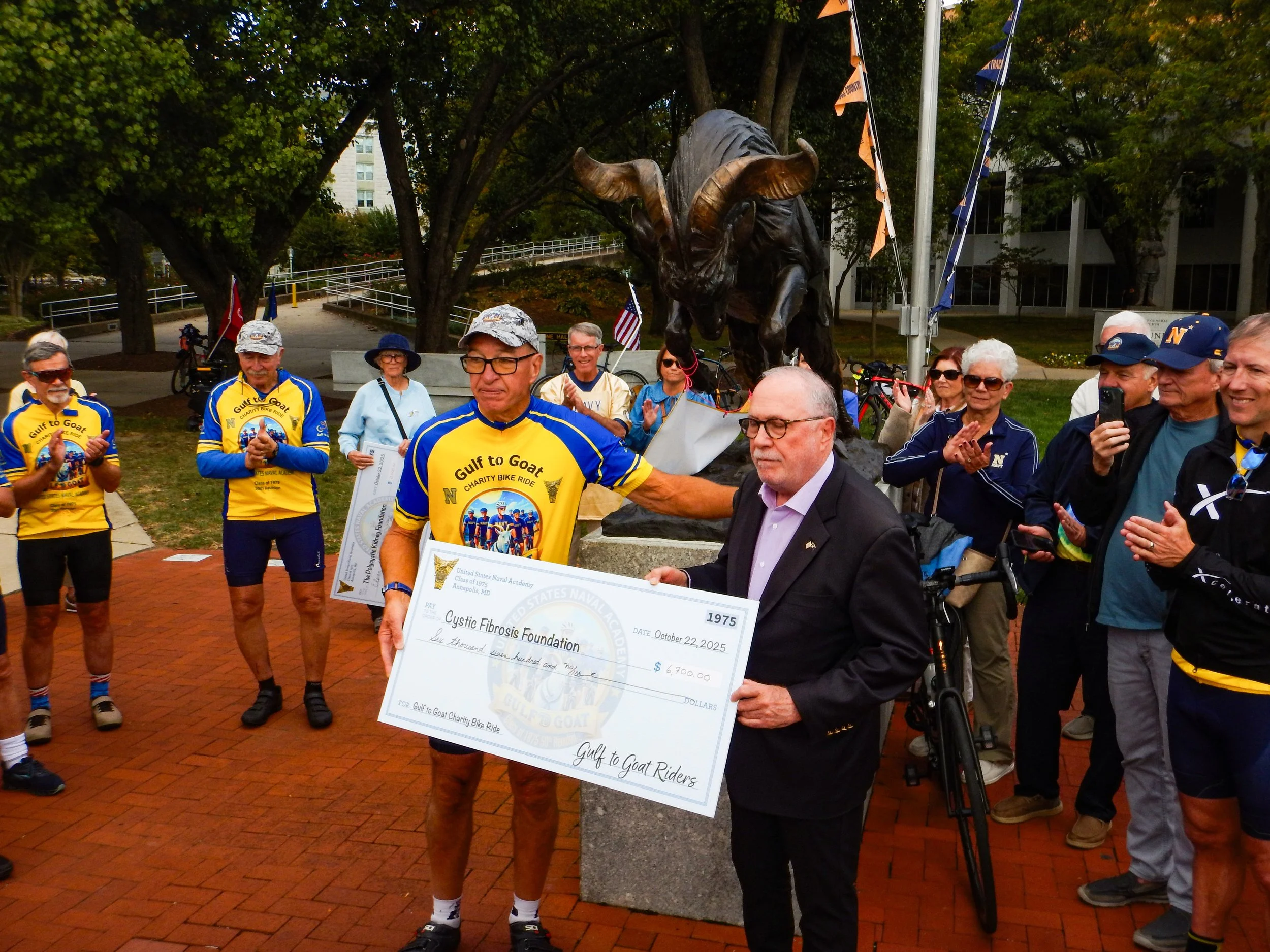 Jeff Simons presents check to Bill Squires for Cystic Fibrosis Foundation