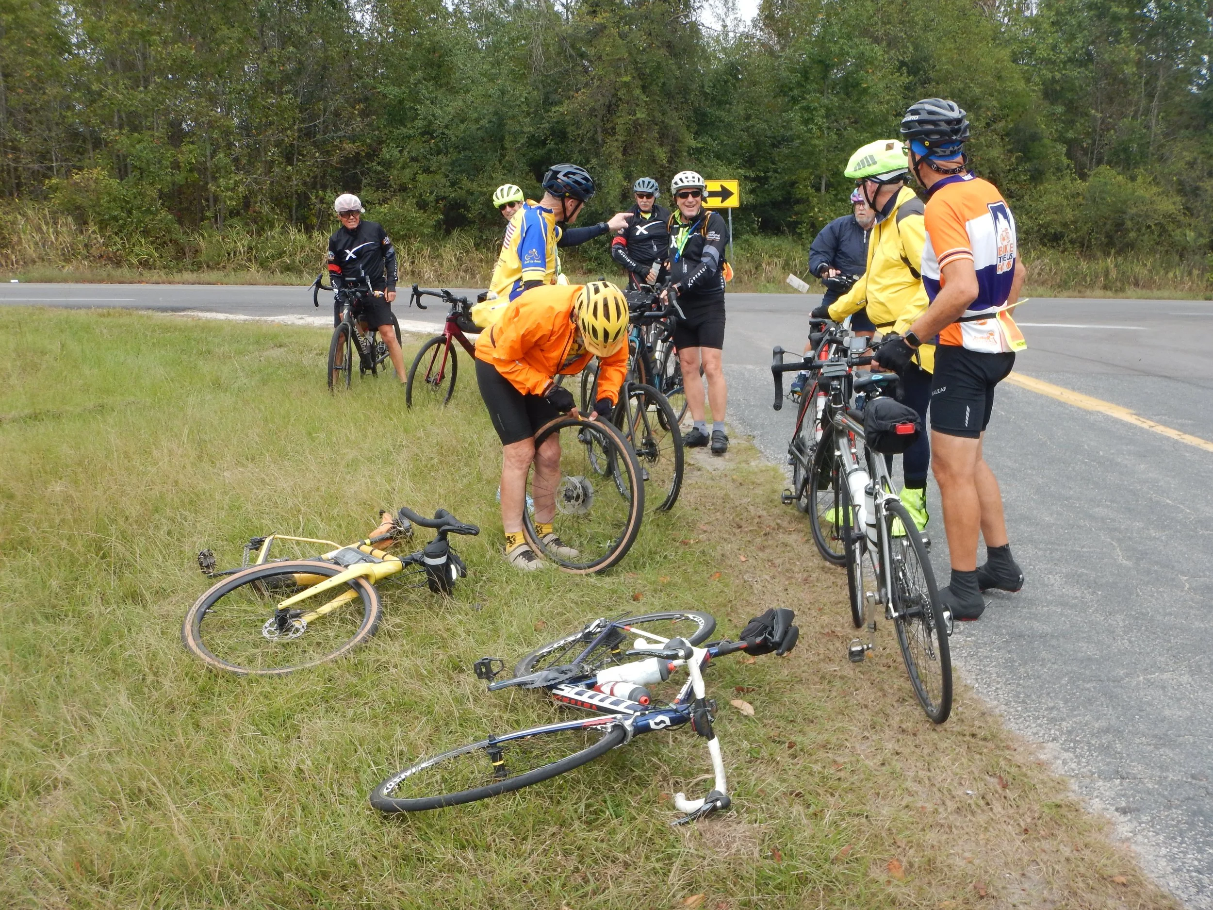 Ten USNA Grads fixing a flat tire