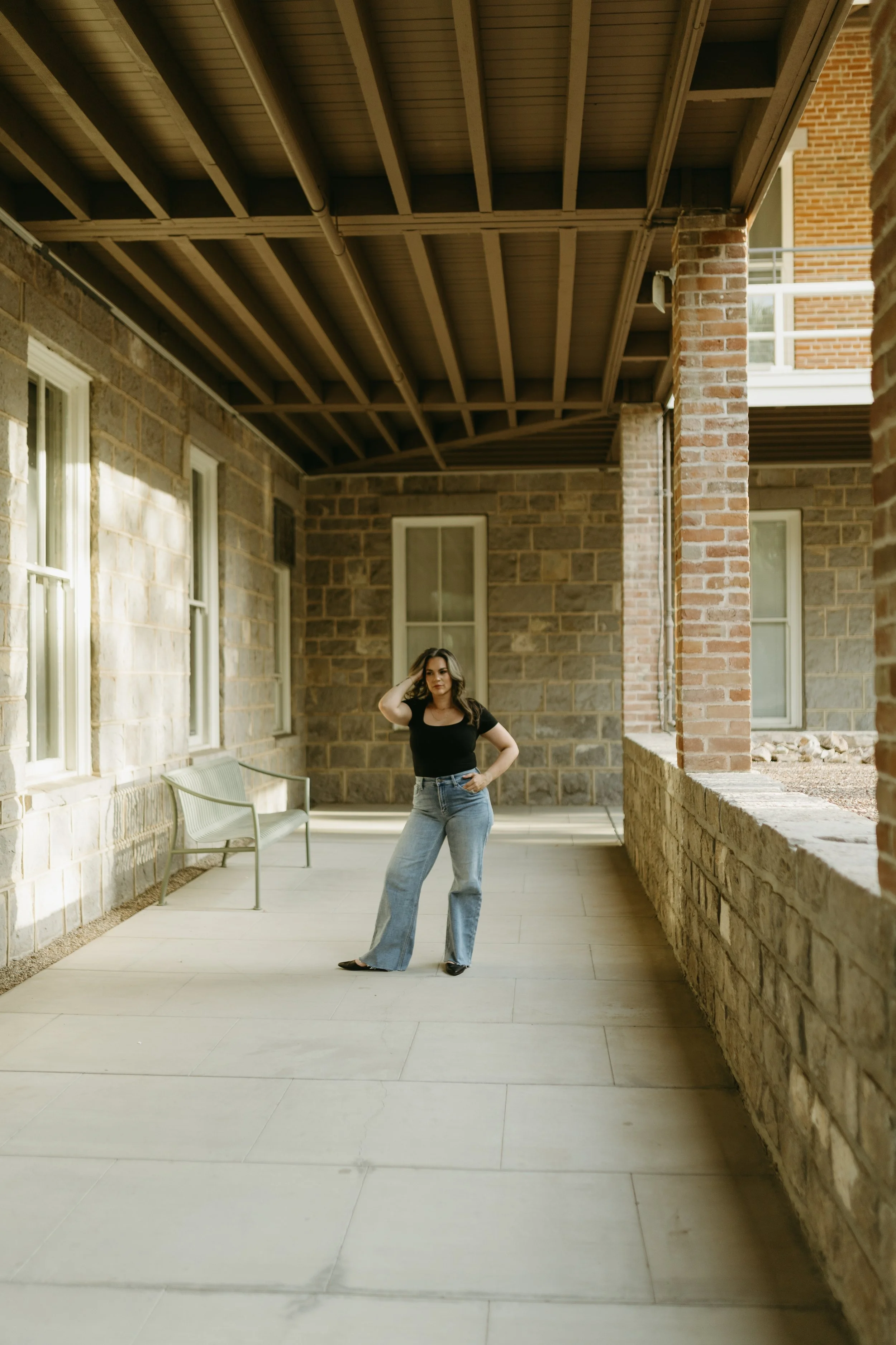 female therapist standing in a hallway pondering