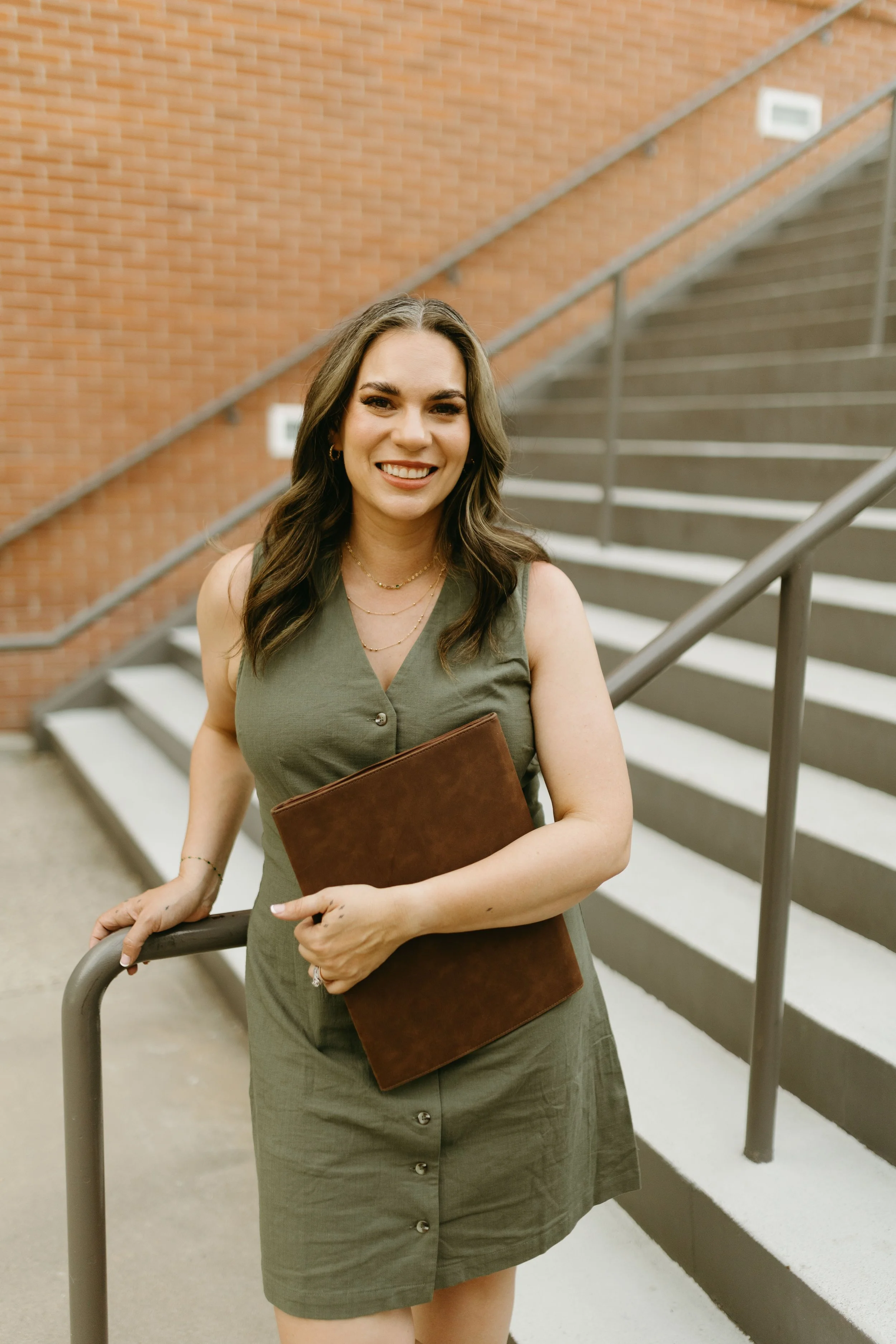 female therapist smiling in front of stairs
