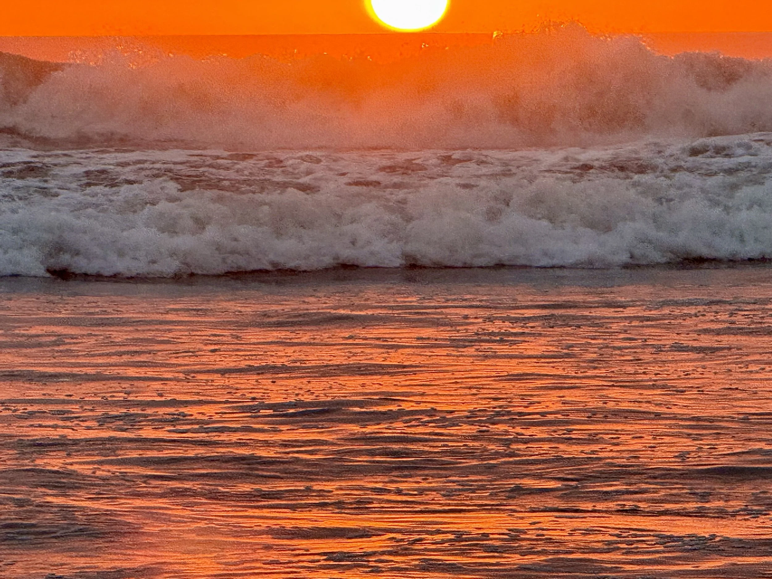 Sun setting in Nosara with splash