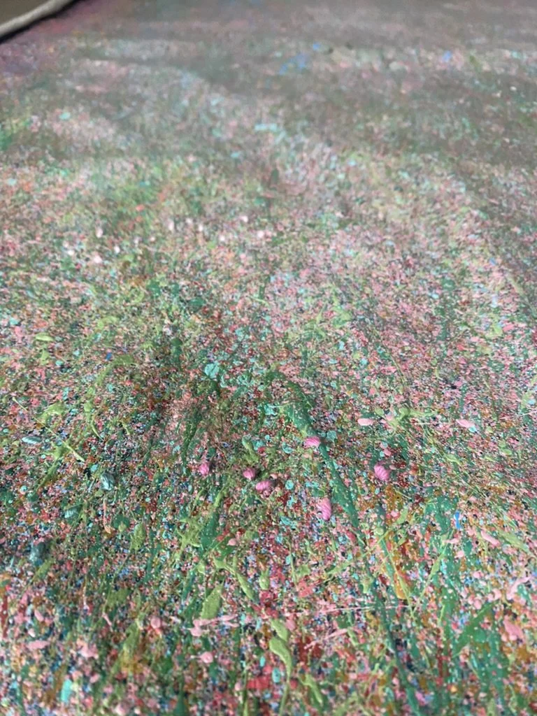 Close-up of Kira Somerset's heavily textured painting, featuring thick layers of pink, blue, and green acrylic and mixed media.
