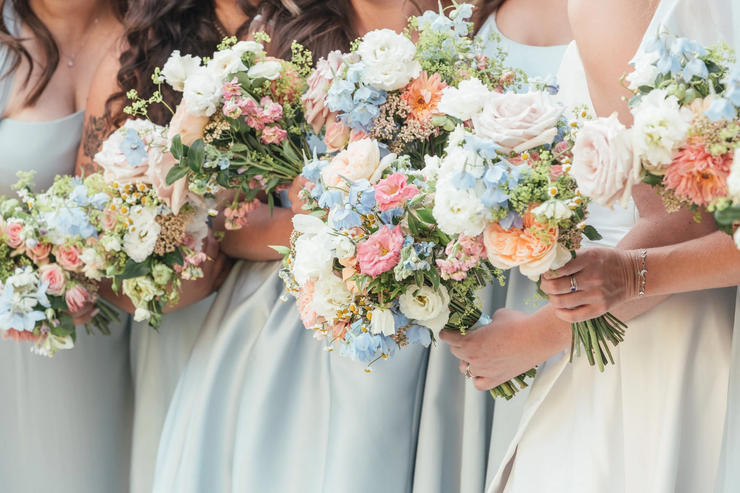 bridesmaids-baby-blue-dresses-pastel-bouquets.jpg