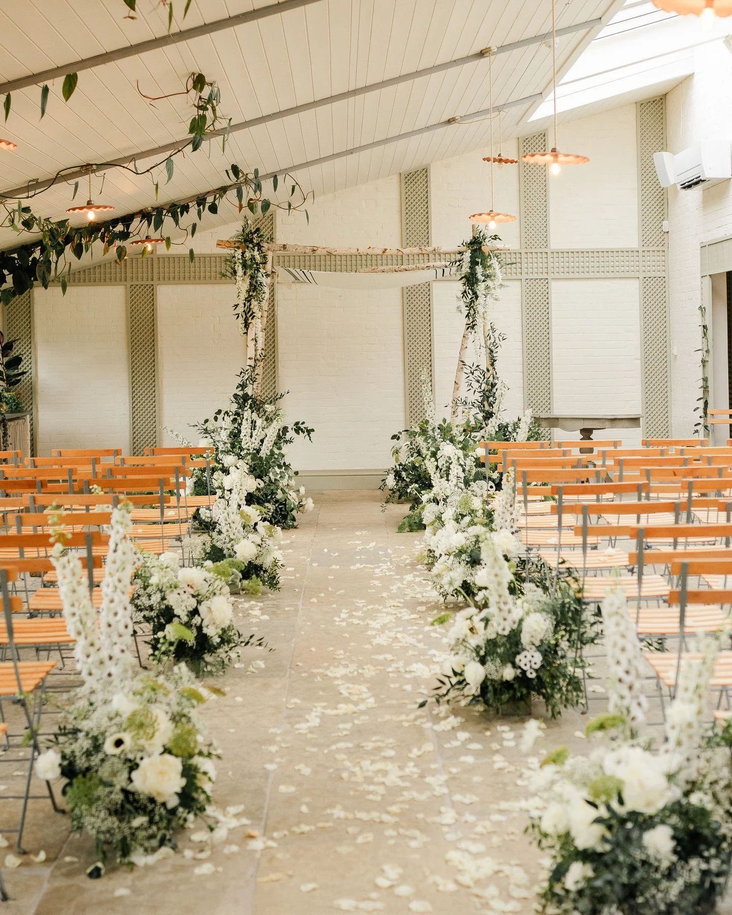 Under the most beautiful chuppah at Kin House. 

This elegant Jewish wedding was all about timeless romance for a black-tie affair. 

White blooms, lush greens with a hint of a dark accent, created dreamy aisle meadows. The perfect blend of classic a