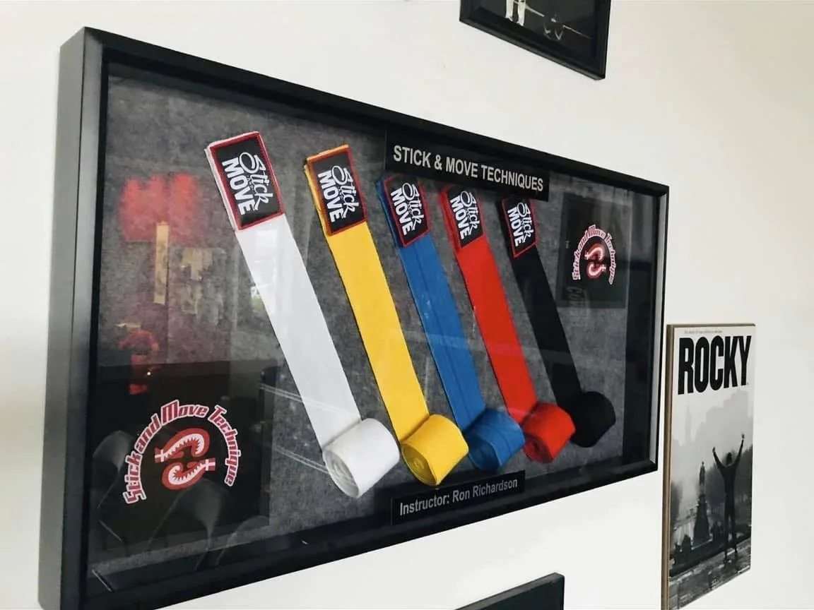 Display case with hand wrap progression arranged from white to black, labeled with 'Stick & Move Techniques.'