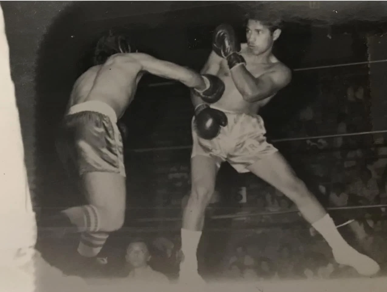 Black-and-white photo of Coach Ron in a bout during his competitive boxing career