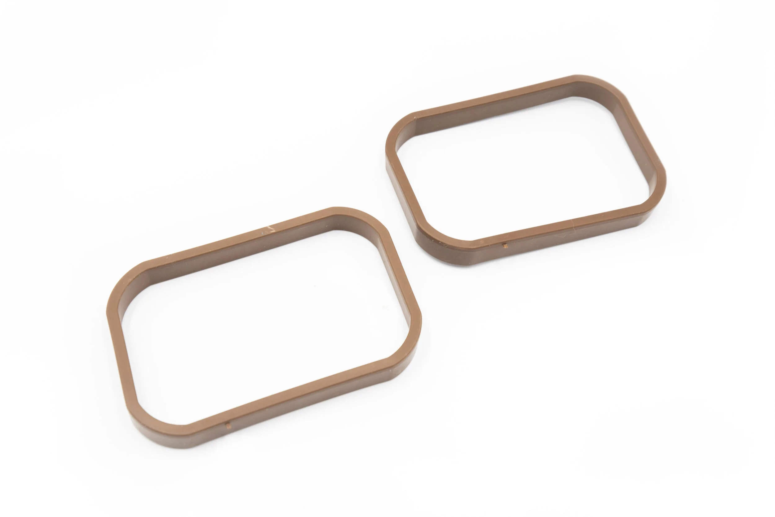 two brown SpoutTrim caps on a white background