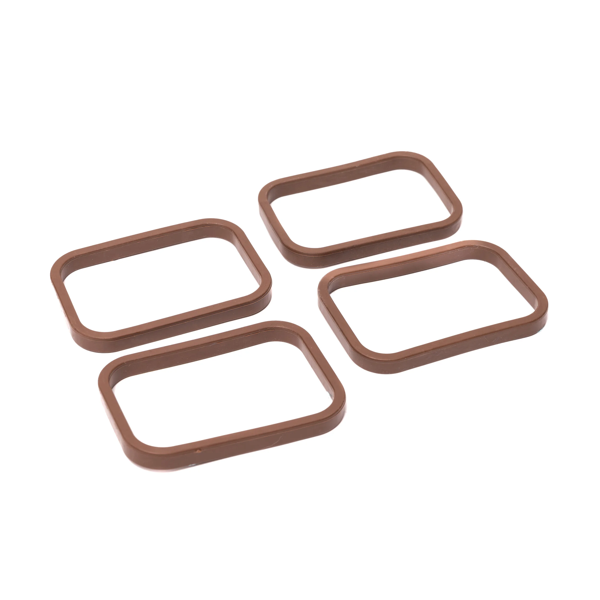 four brown SpoutTrim caps on a white background