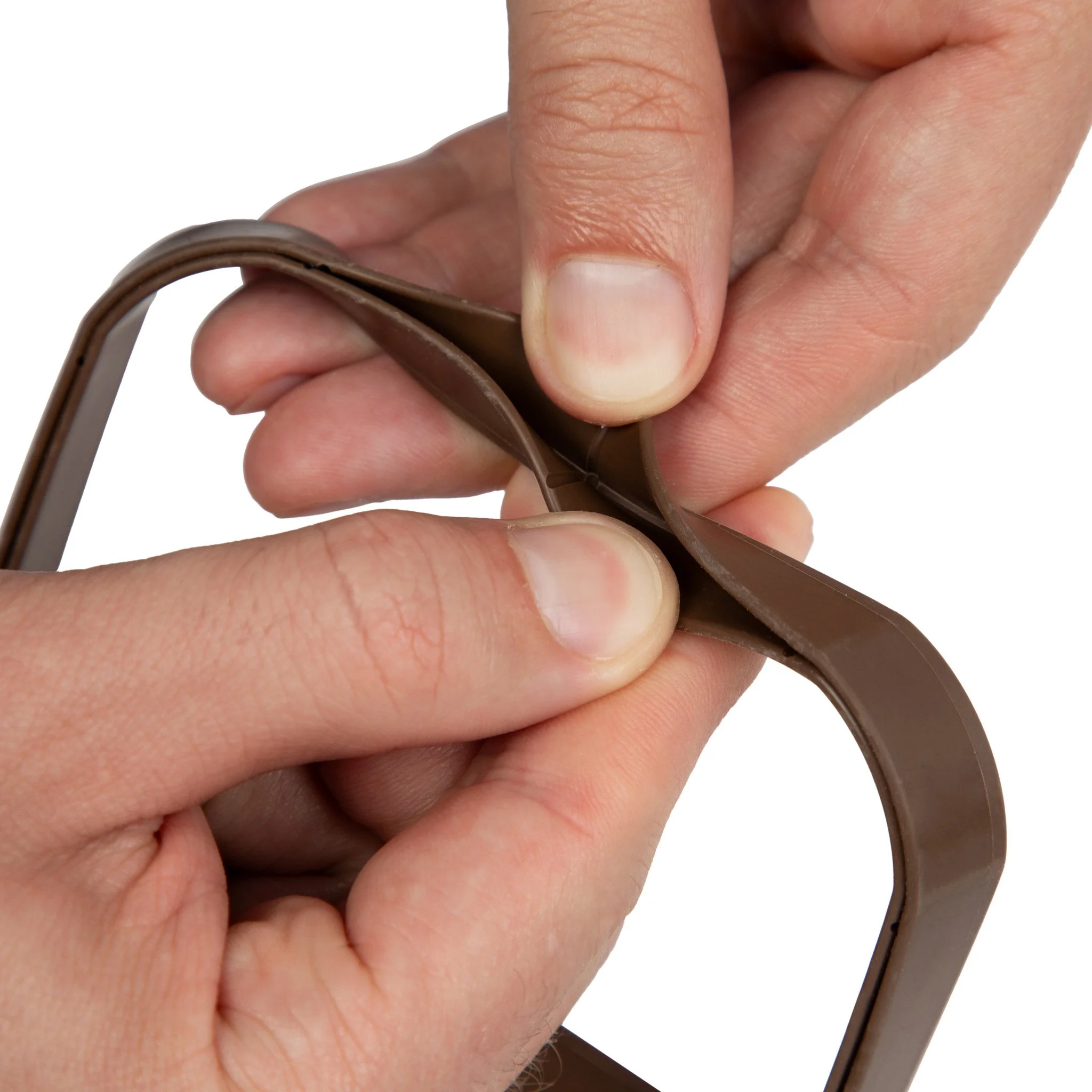 hands pulling apart the edges of a SpoutTrim cap to show the channel recessed inside